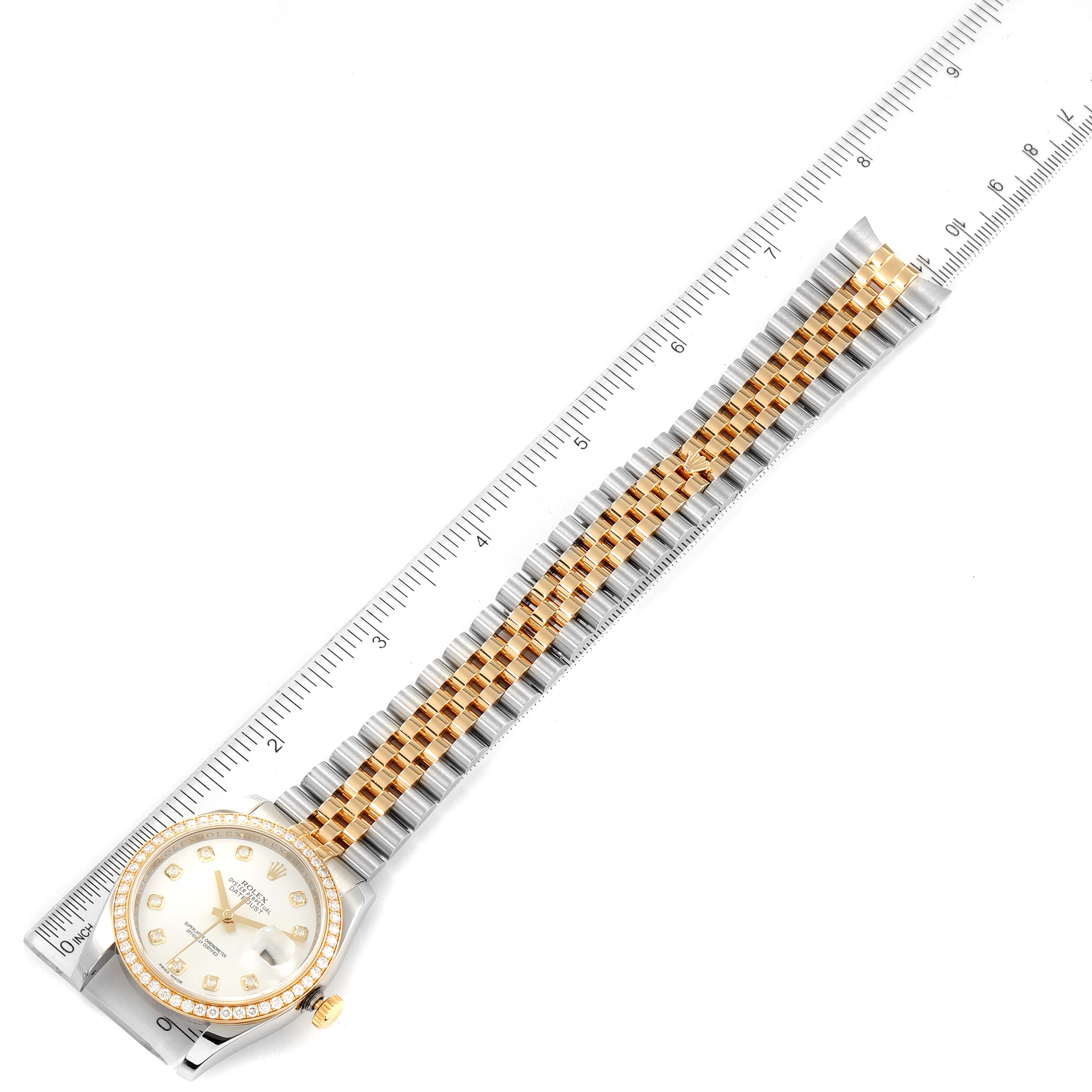 This image shows a top view of a Rolex Datejust 116243 Men's Steel and Gold (two tone) White Dial 116243 Men's Steel and Gold (two tone) White Dial watch, highlighting the dial, case, bezel, and two-tone bracelet with a ruler for scale.