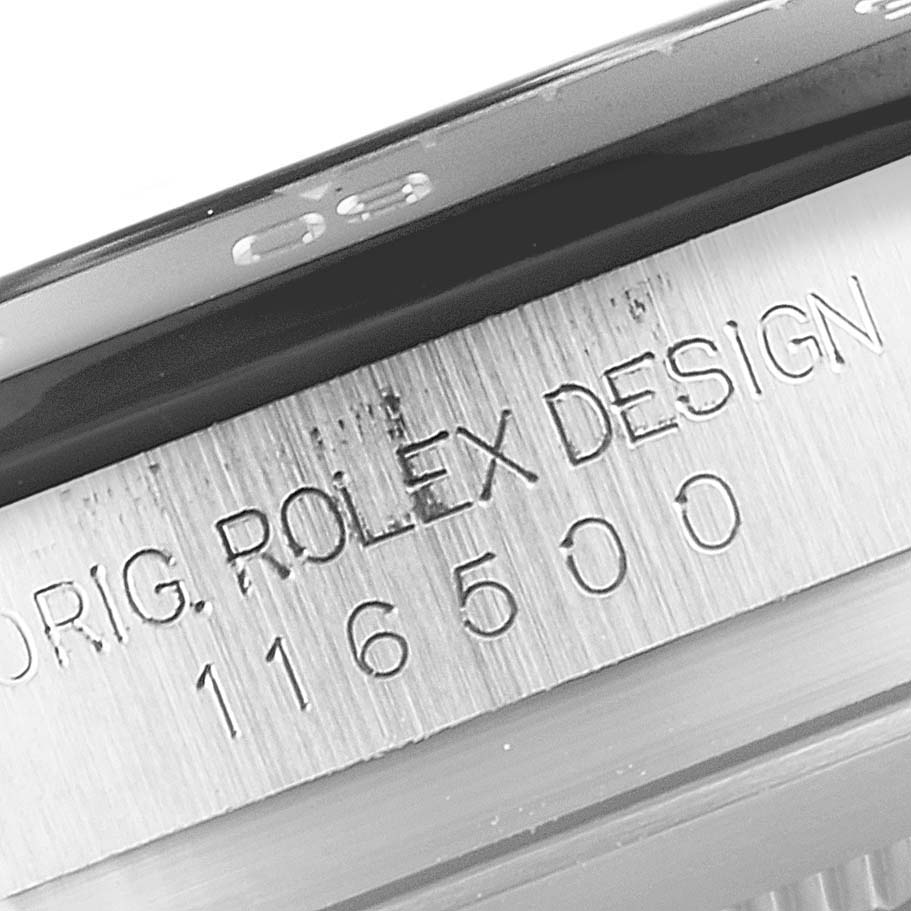 This close-up image shows the engravings on the side of the bezel and case of a Rolex Daytona 116500 Men's Stainless Steel White Dial 116500 Men's Stainless Steel White Dial watch.