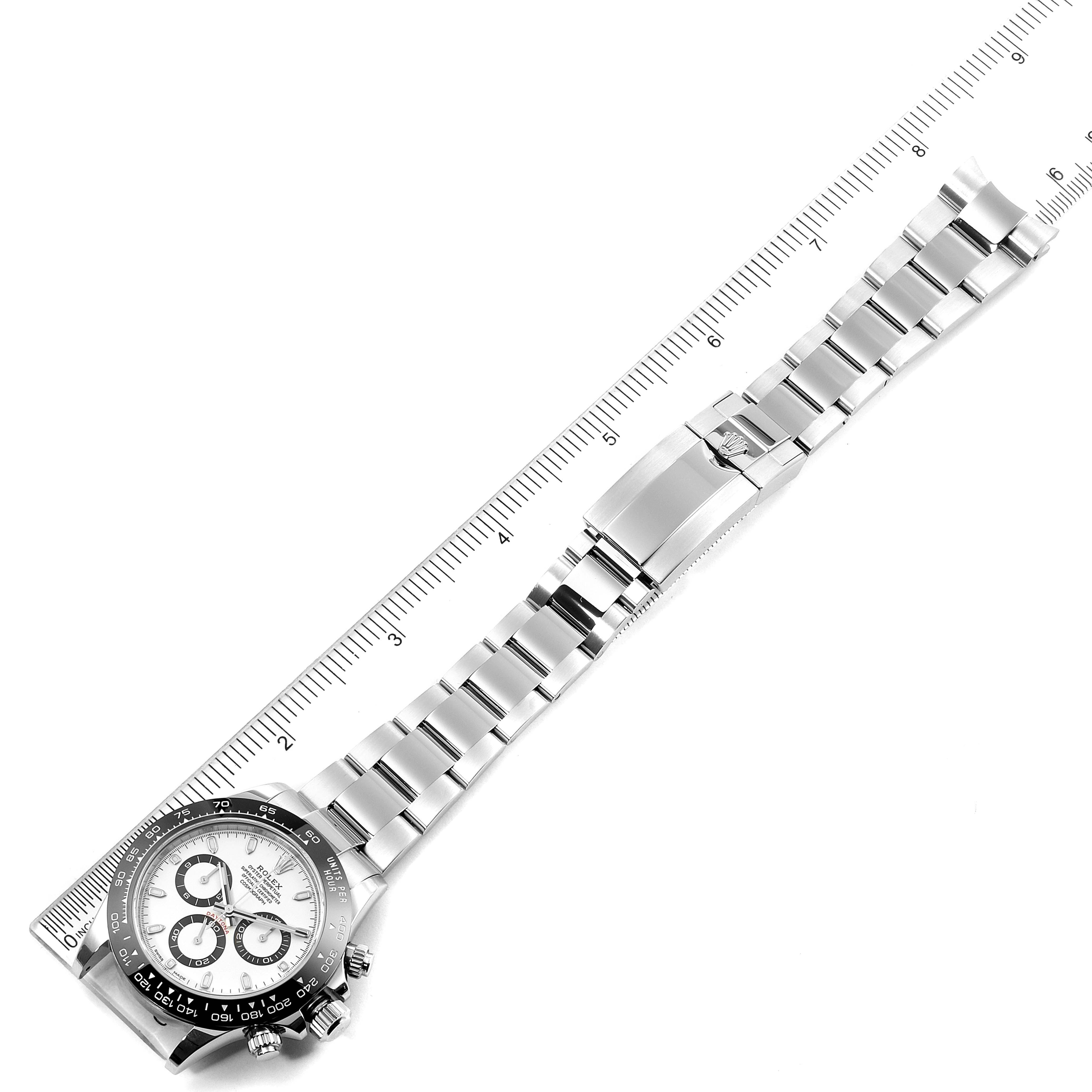 The image shows a Rolex Daytona 116500 Men's Stainless Steel White Dial 116500 Men's Stainless Steel White Dial watch in a flat, top-down angle, displaying the dial and entire bracelet with a ruler for scale.