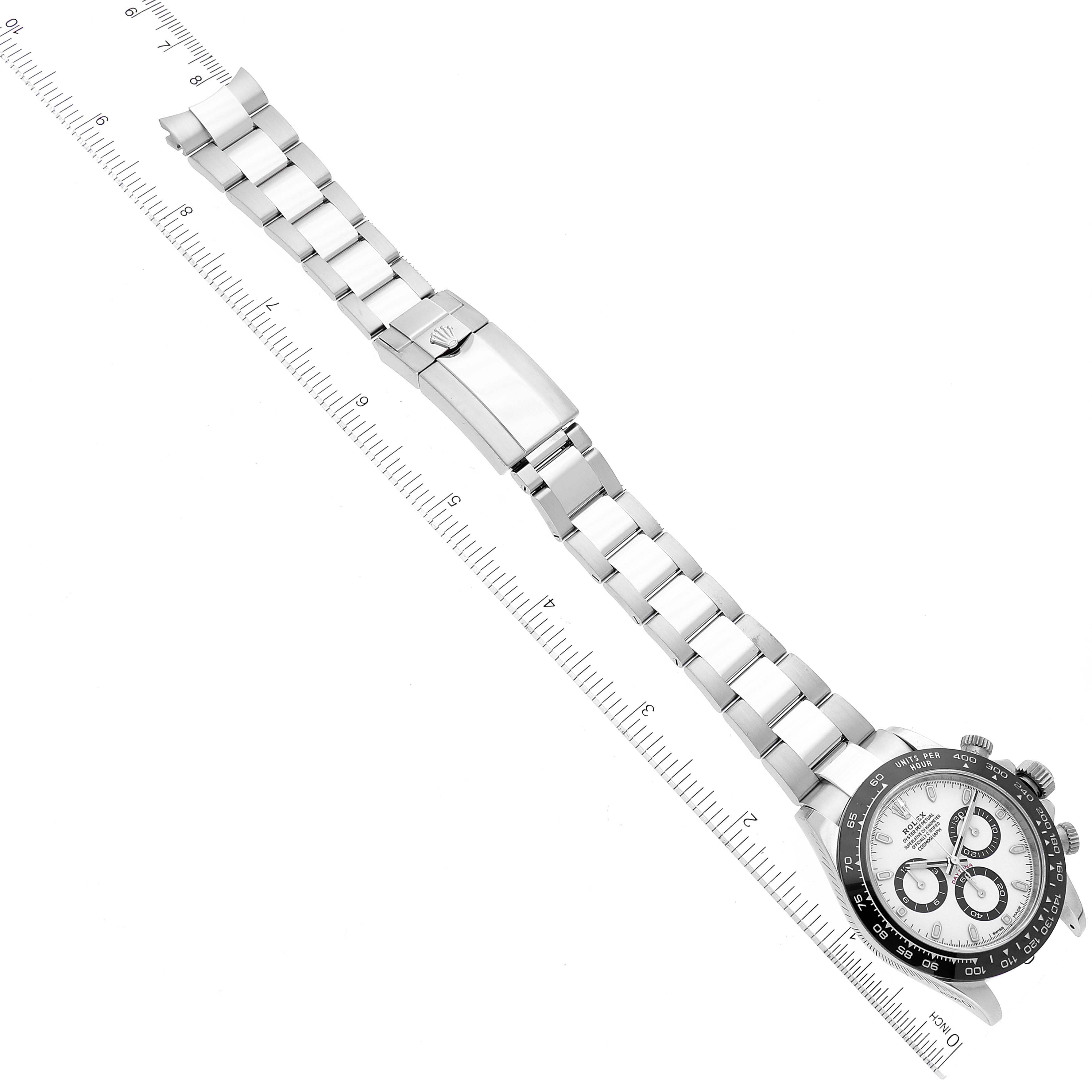 Top-down view of the Rolex Daytona 116500 Men's Stainless Steel White Dial 116500 Men's Stainless Steel White Dial watch showing the face, bezel, and full bracelet on a ruler.