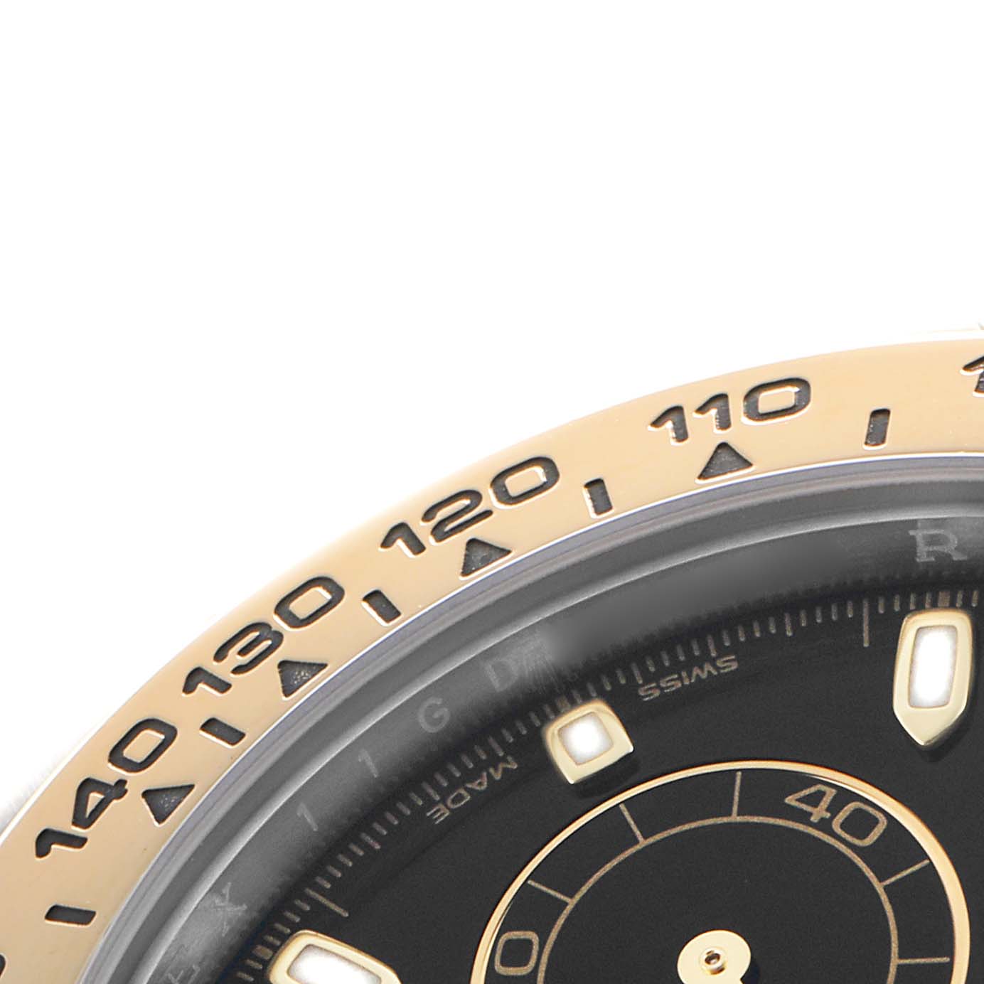 The image shows a close-up of the bezel and part of the dial of a Rolex Daytona 116503 Men's Steel and Gold (two tone) Black Dial, highlighting the tachymetric scale.