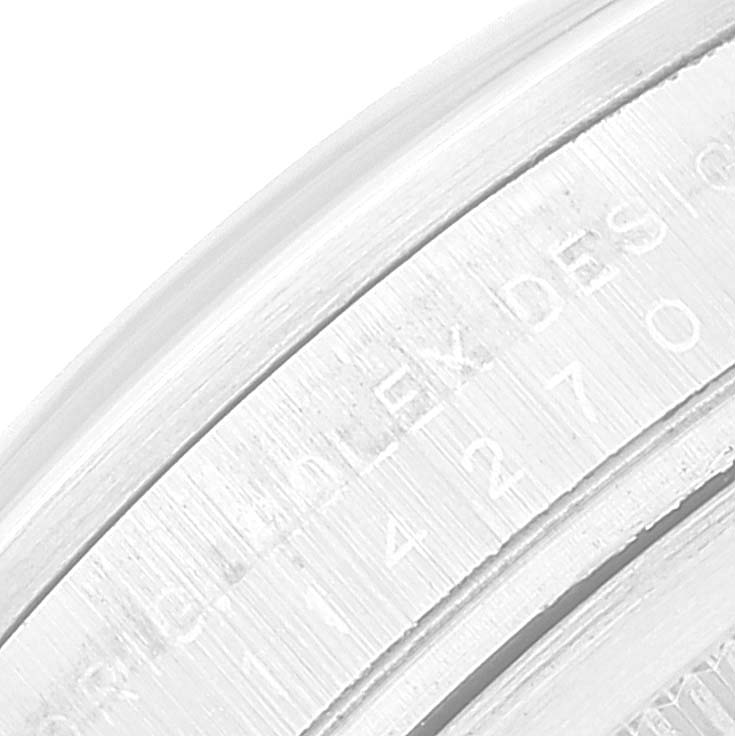 The image shows the engraving on the inner bezel of a Rolex Explorer 114270 Men
s Stainless Steel Black Dial 114270 Men
s Stainless Steel Black Dial watch.