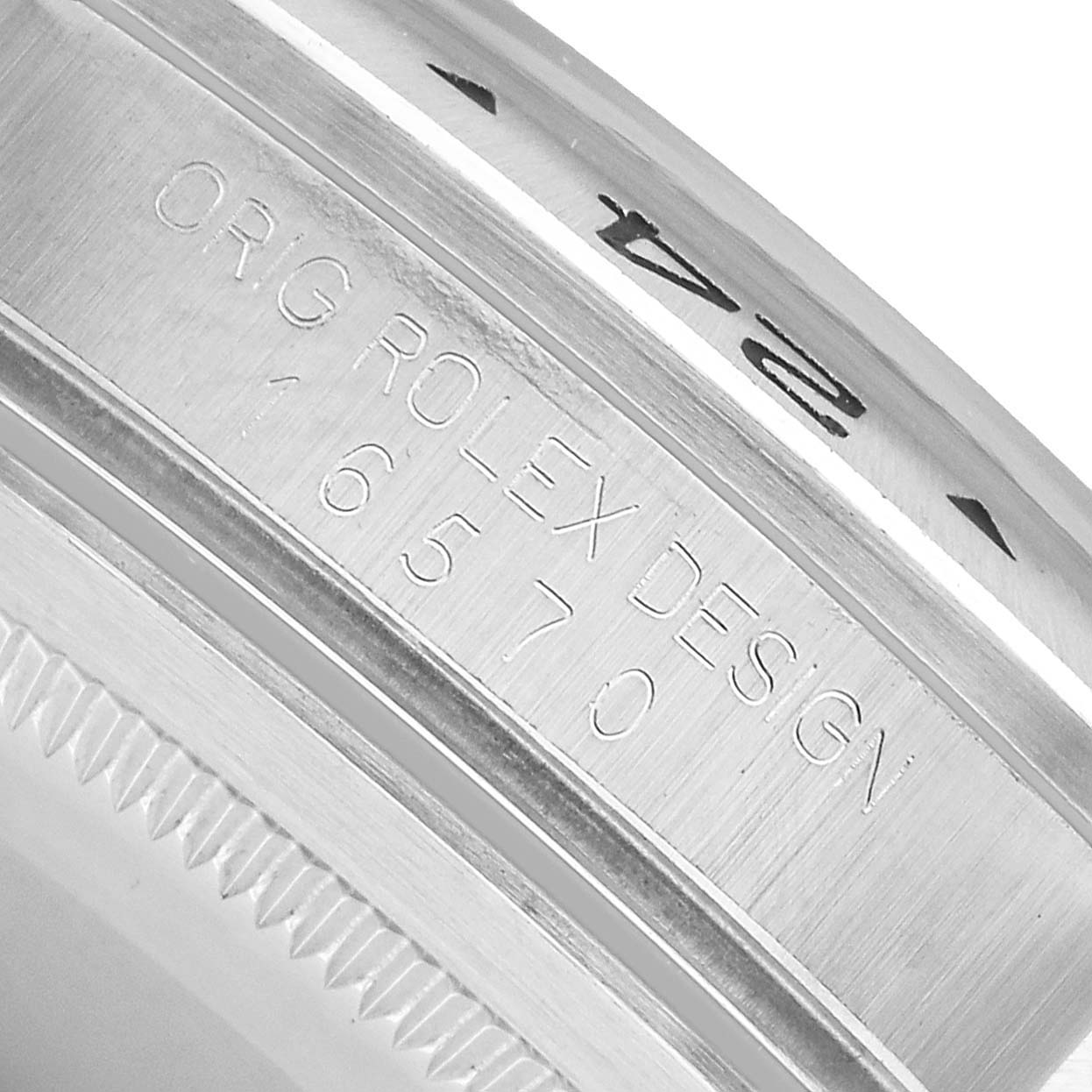 The image shows a close-up of the rim and bezel engraving on a Rolex Explorer 16570 Men's Stainless Steel Black Dial watch.