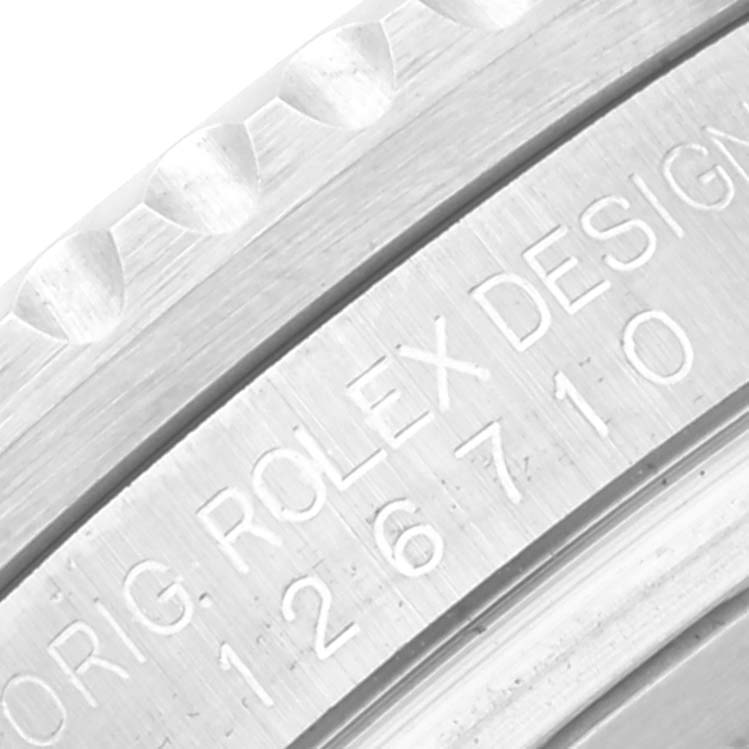 This close-up image shows the engraved side of the case and the bezel of the Rolex GMT-Master 126710 Men's Stainless Steel Black Dial 126710 Men's Stainless Steel Black Dial watch.
