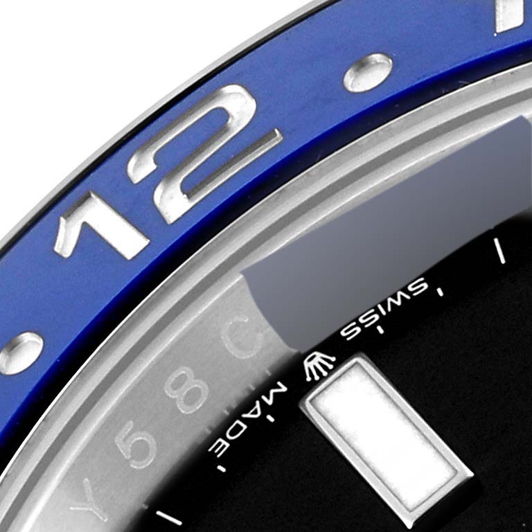 The image shows a close-up of the bezel and part of the dial of a Rolex GMT-Master 126710 Men's Stainless Steel Black Dial 126710 Men's Stainless Steel Black Dial watch, highlighting the numbers, "Swiss Made," and markers.