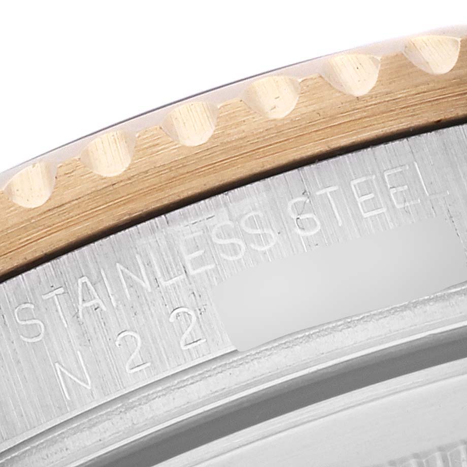 This close-up image of a Rolex GMT-Master 16713 Men's Steel and Gold (two tone) Black Dial 16713 Men's Steel and Gold (two tone) Black Dial shows the watch's stainless steel casing and part of the bezel.