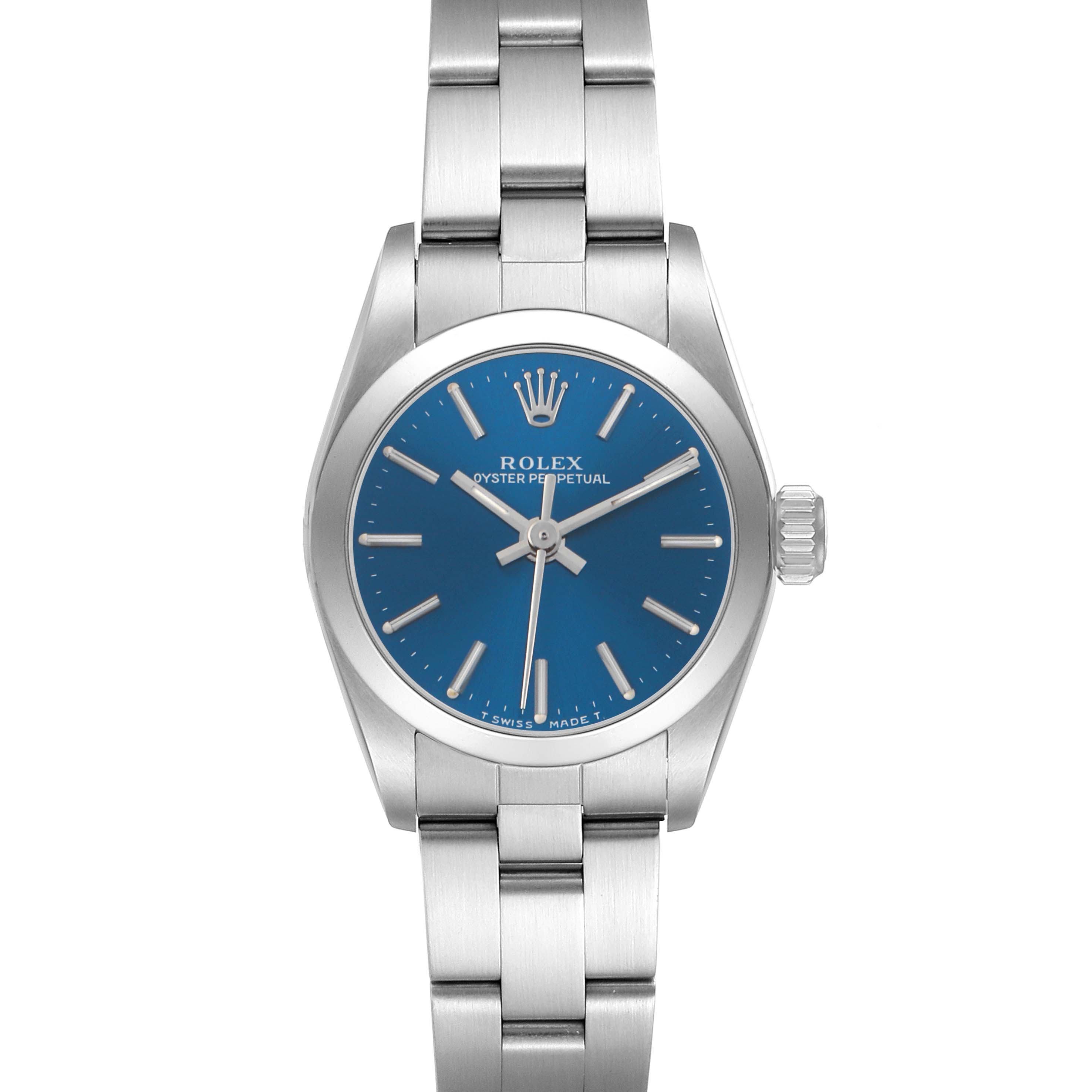 The Rolex Oyster Perpetual 67180 Women's Stainless Steel Blue Dial watch is shown from a top-down angle, displaying the blue dial, bezel, crown, and bracelet.