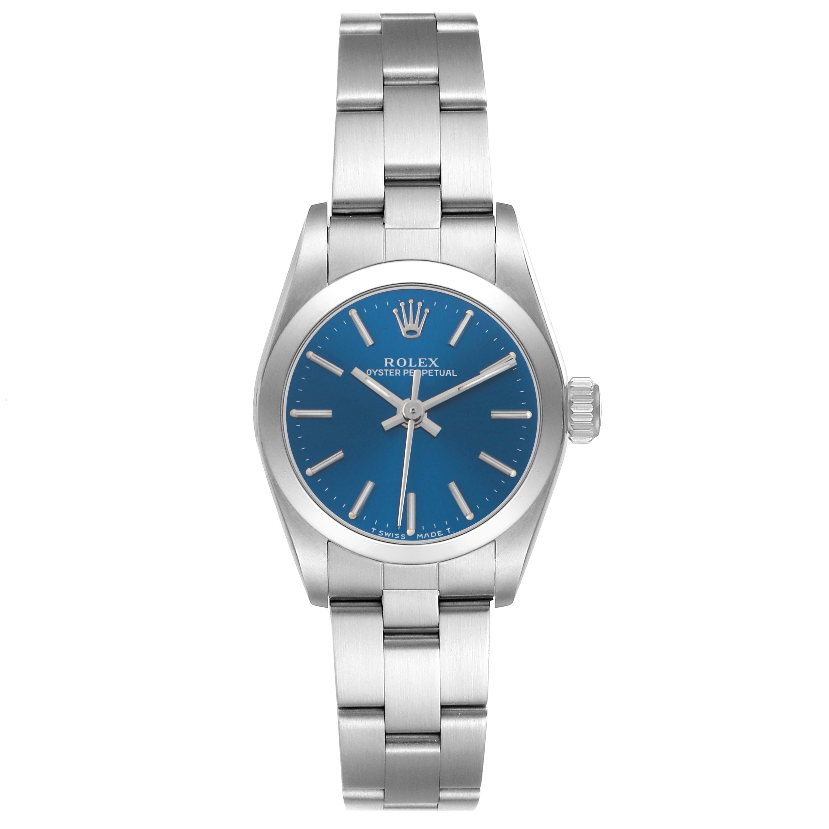 The image shows a front view of a Rolex Oyster Perpetual 67180 Women's Stainless Steel Blue Dial watch, highlighting the blue dial, silver hour markers, and stainless steel bracelet.