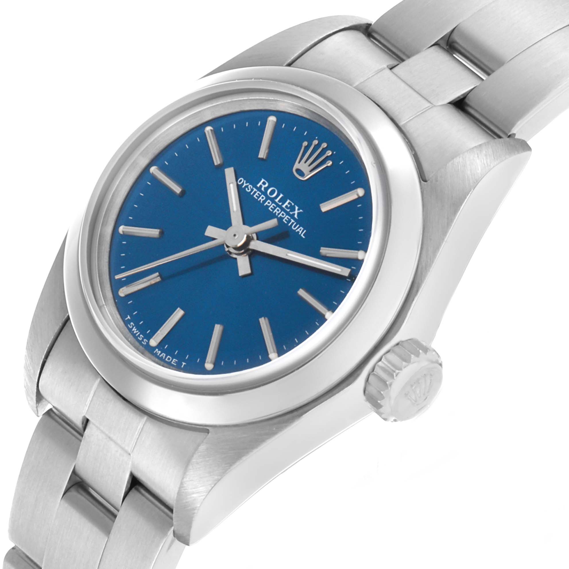 The Rolex Oyster Perpetual 67180 Women's Stainless Steel Blue Dial watch is shown at a slight angle from the front, highlighting the blue dial, crown, and bracelet links.