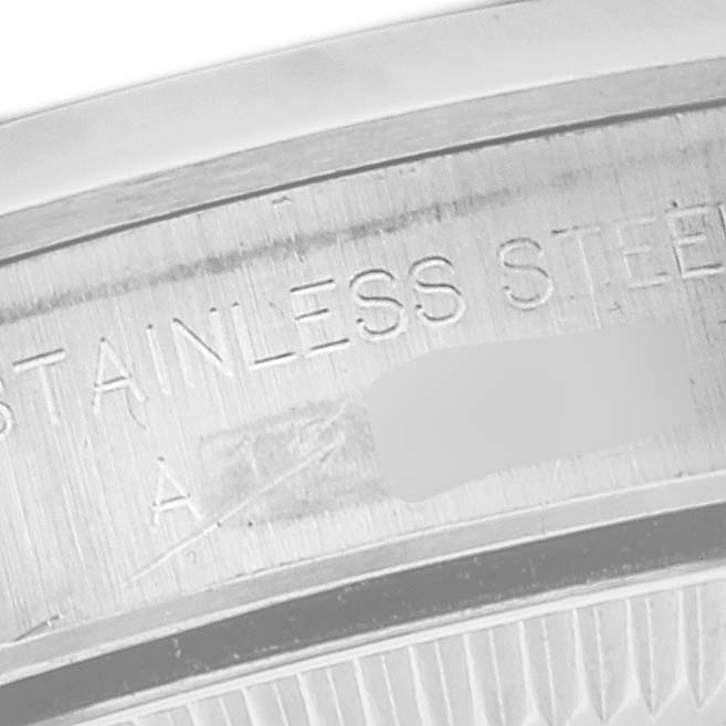 The image shows a close-up of the side engraving on a Rolex Oyster Perpetual 67180 Women's Stainless Steel Black Dial 67180 Women's Stainless Steel Black Dial watch, highlighting its stainless steel material.