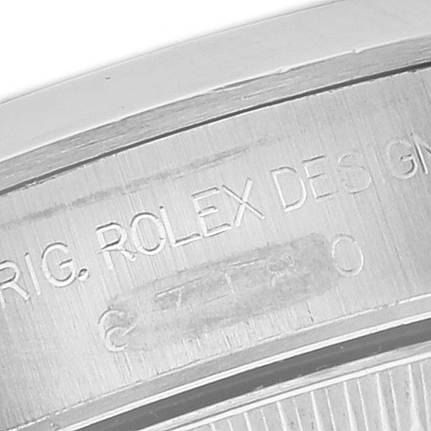 This image shows a close-up view of the engraved details on the case back of a Rolex Oyster Perpetual 67180 Women's Stainless Steel Black Dial 67180 Women's Stainless Steel Black Dial watch.