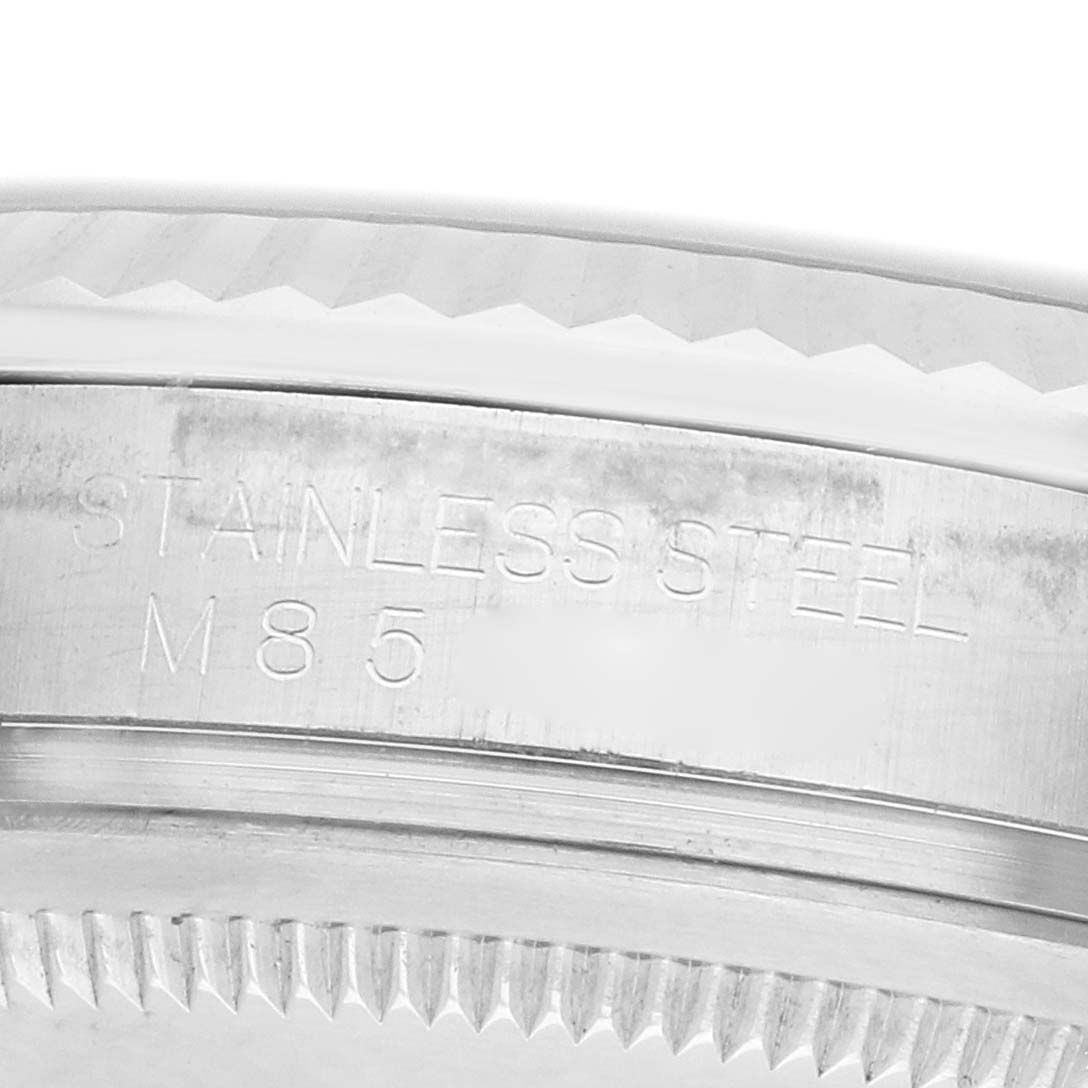 The image shows a close-up of the side of the bezel and case edge of a Rolex Oyster Perpetual 116034 Men's Stainless Steel Silver Dial, displaying the stainless steel engraving.