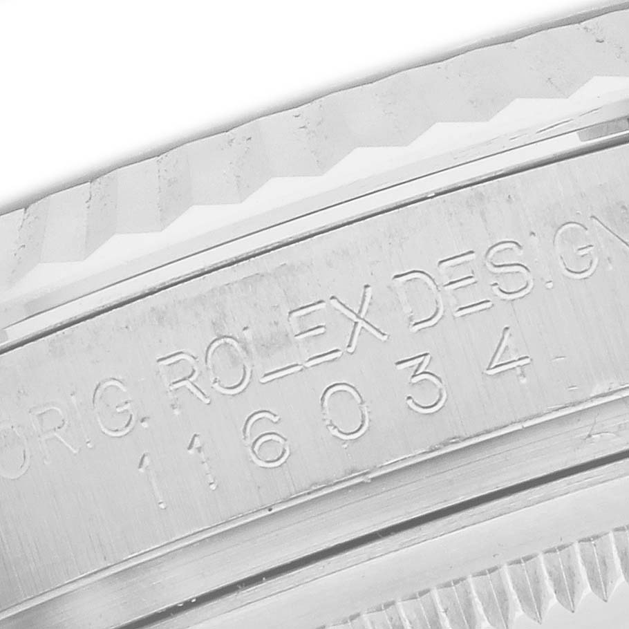 The image shows a close-up of the side engraving on a Rolex Oyster Perpetual 116034 Men's Stainless Steel Silver Dial watch bezel.