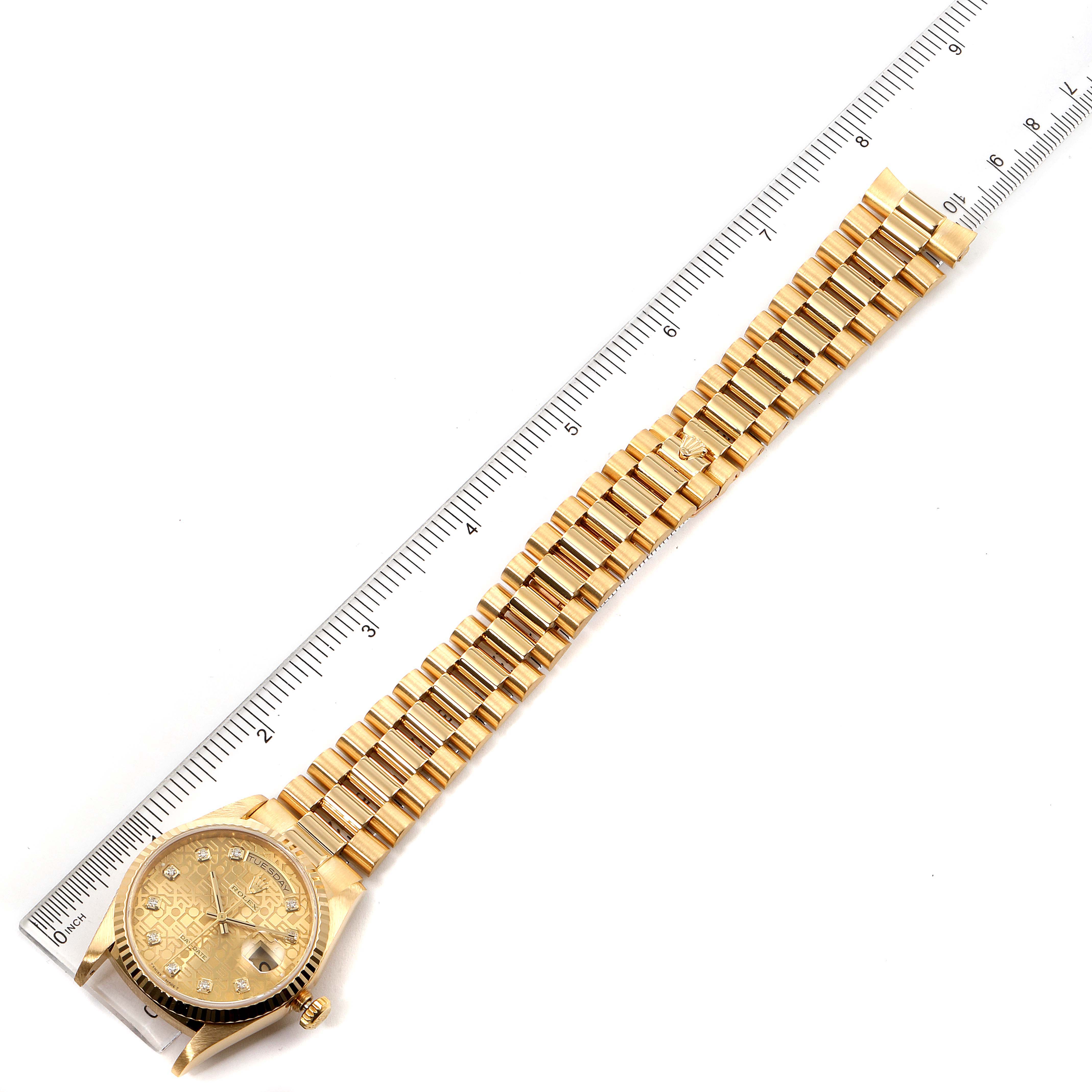 The image shows a Rolex President 18238 Men's Yellow Gold Champagne Dial 18238 Men's Yellow Gold Champagne Dial model watch positioned next to a ruler, viewed from above displaying the entire band and face.