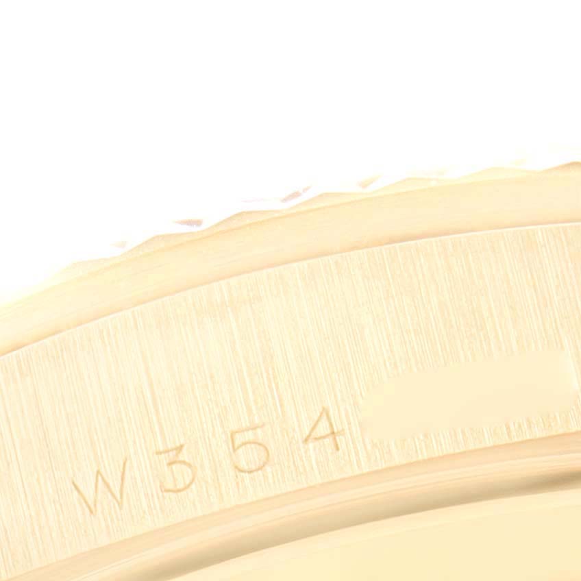 This image shows an extreme close-up of the Rolex President 18238 Men's Yellow Gold Champagne Dial 18238 Men's Yellow Gold Champagne Dial model watch case with partial serial numbers visible.