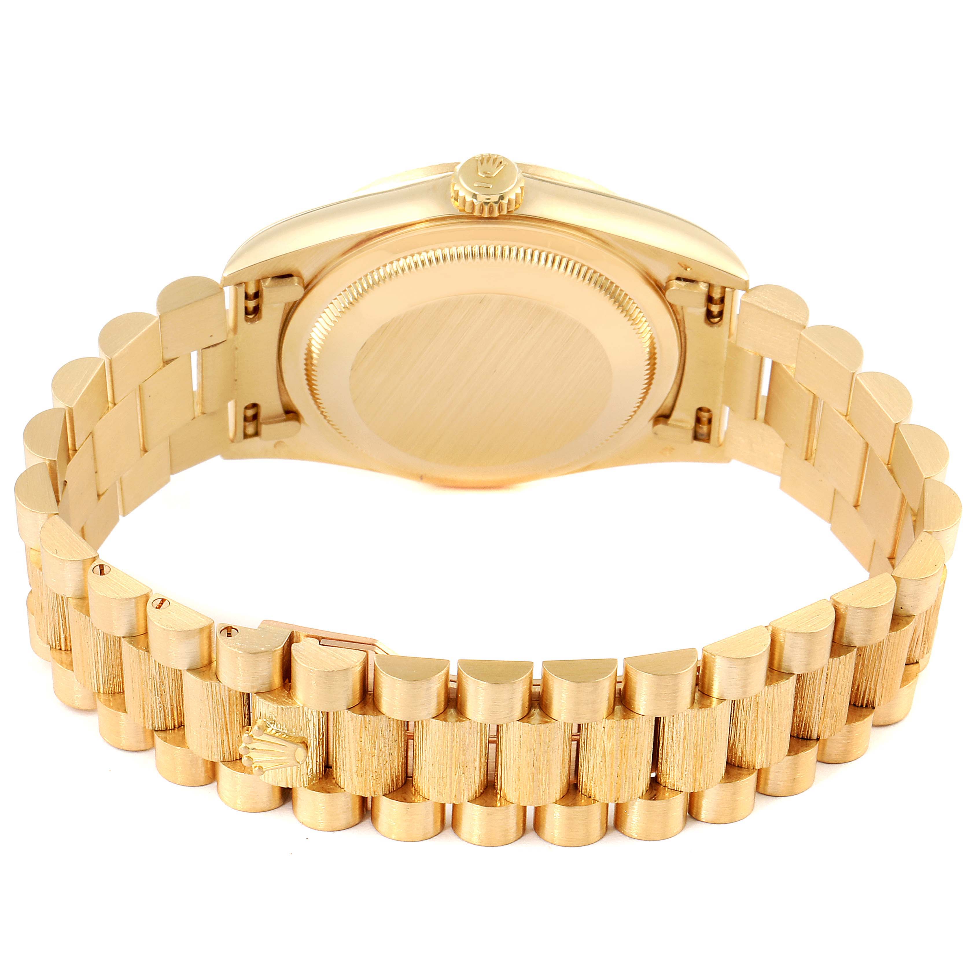 The image shows the back side of a Rolex President 18248 Men
s Yellow Gold Champagne Dial 18248 Men
s Yellow Gold Champagne Dial model watch and its gold bracelet.