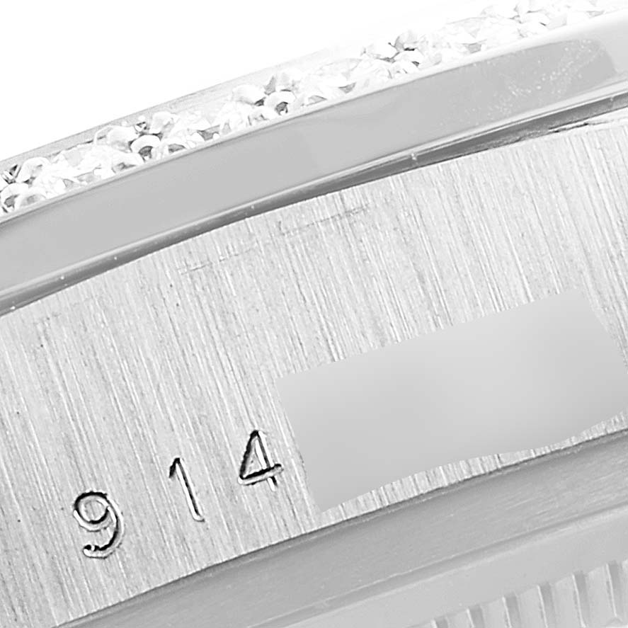 The image shows a close-up of the engraved serial number and part of the bezel of a Rolex President 18049 Men
s White Gold Silver Dial 18049 Men
s White Gold Silver Dial model watch.