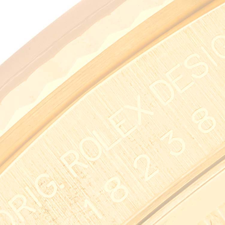 The image shows a close-up of the engraving on the edge of the Rolex President 18238 Men
s Yellow Gold Champagne Dial 18238 Men
s Yellow Gold Champagne Dial model watch.