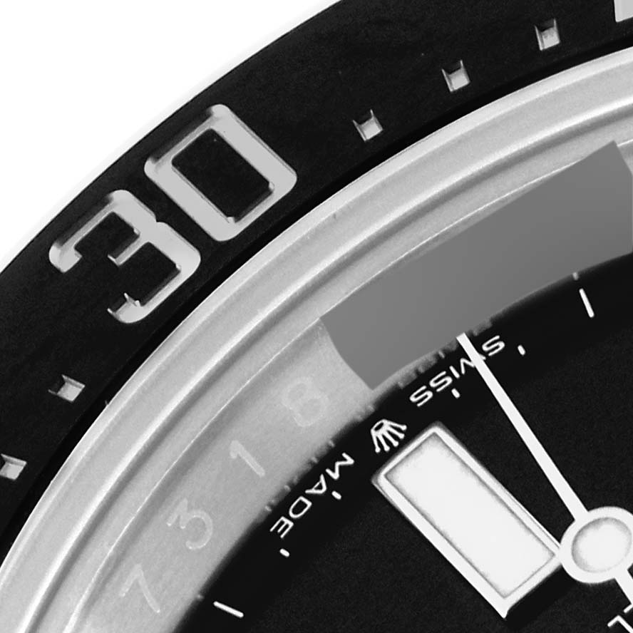 This close-up image of the Rolex Sea-Dweller 126600 Men
s Stainless Steel Black Dial 126600 Men
s Stainless Steel Black Dial watch shows part of the bezel with the number "30" and a portion of the dial.