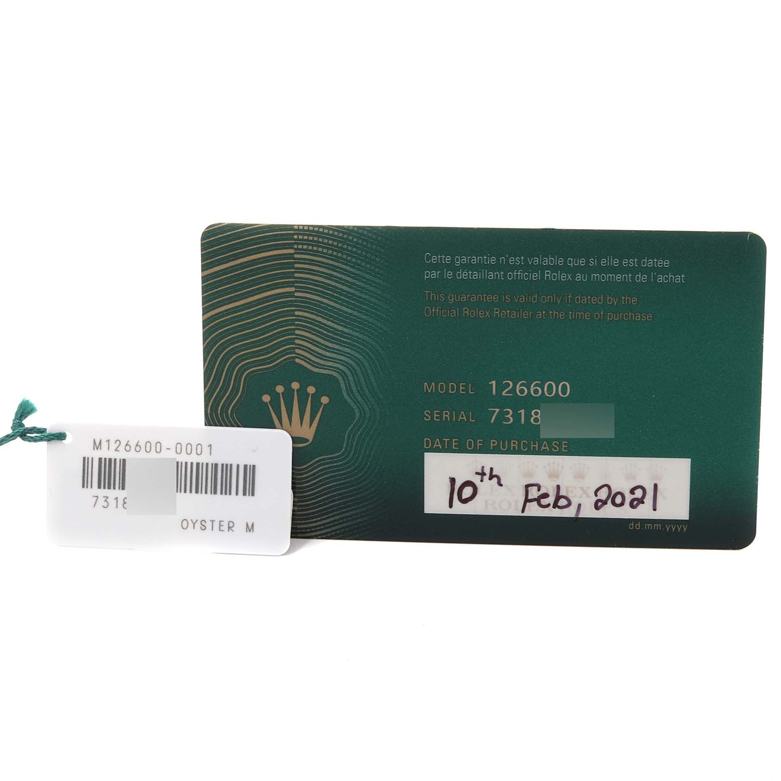 The image shows the warranty card and tag for the Rolex Sea-Dweller 126600 Men
s Stainless Steel Black Dial 126600 Men
s Stainless Steel Black Dial model 126600, displaying purchase details and serial number.