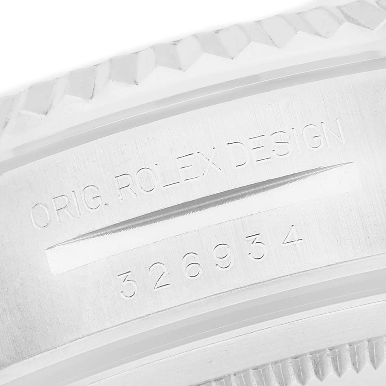 The image shows a close-up of the engraved text on the outer rim of a Rolex Sky-Dweller 326934 Men's Stainless Steel Black Dial watch.