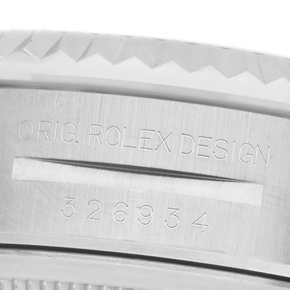 The image shows a close-up of the engraved outer rim of the Rolex Sky-Dweller 326934 Men's Stainless Steel Black Dial, featuring its design and model number.