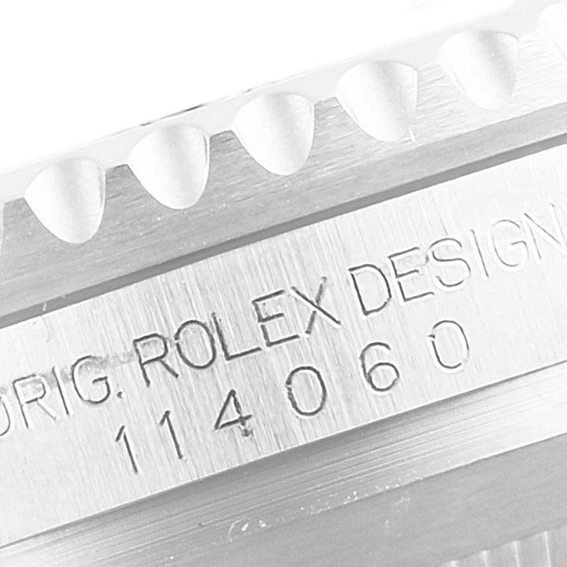 This image shows a close-up of the Rolex Submariner 114060 Men's Stainless Steel Black Dial 114060 Men's Stainless Steel Black Dial's case side with serial and model number engravings.