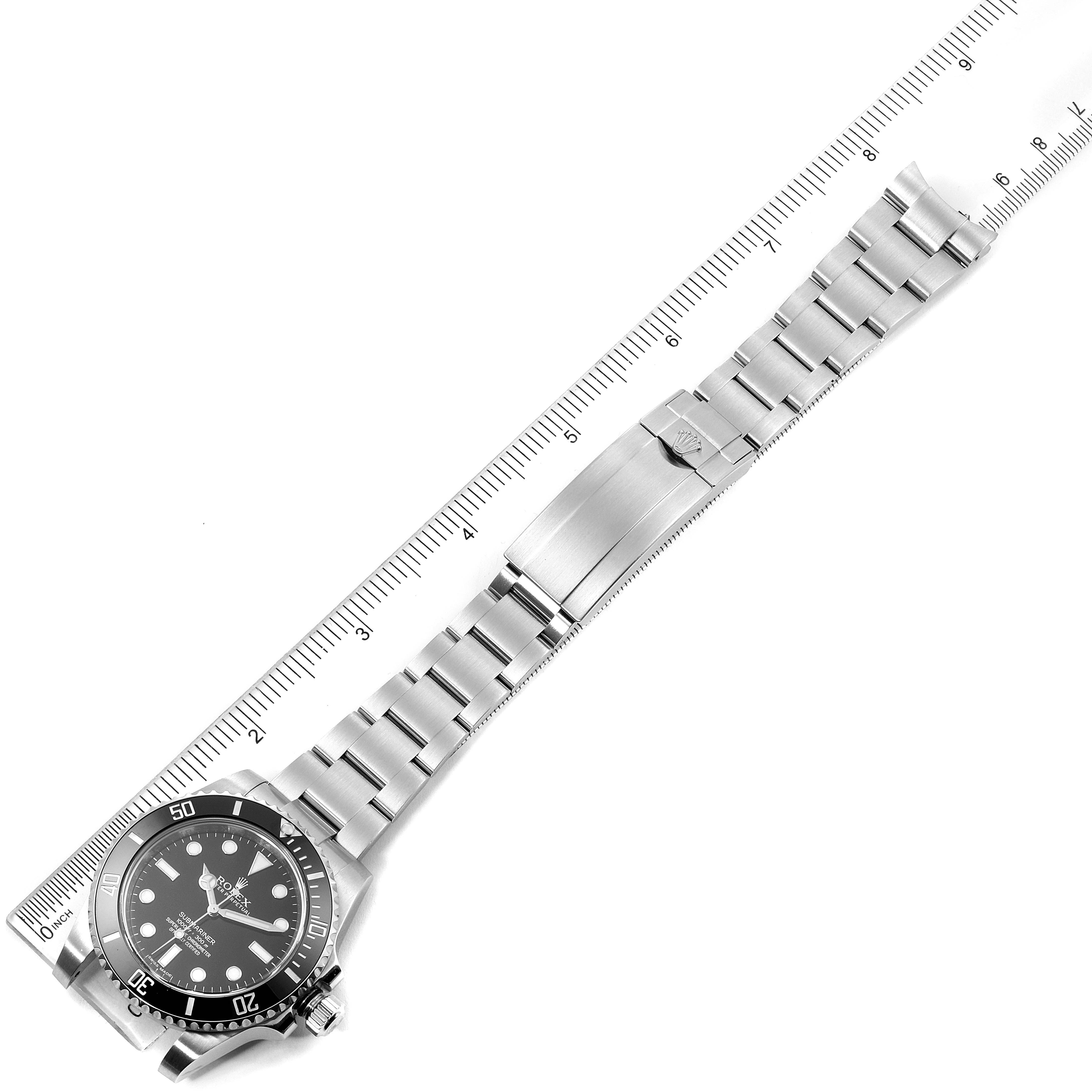 The image shows a full-length view of a Rolex Submariner 114060 Men's Stainless Steel Black Dial 114060 Men's Stainless Steel Black Dial watch laid flat with a ruler beside it for measurement.