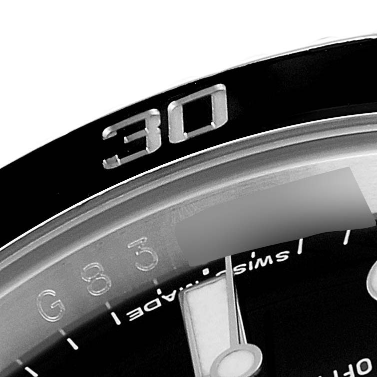 This close-up image shows part of the bezel, minute hand, and dial of a Rolex Submariner 116610 Men's Stainless Steel Black Dial 116610 Men's Stainless Steel Black Dial watch.