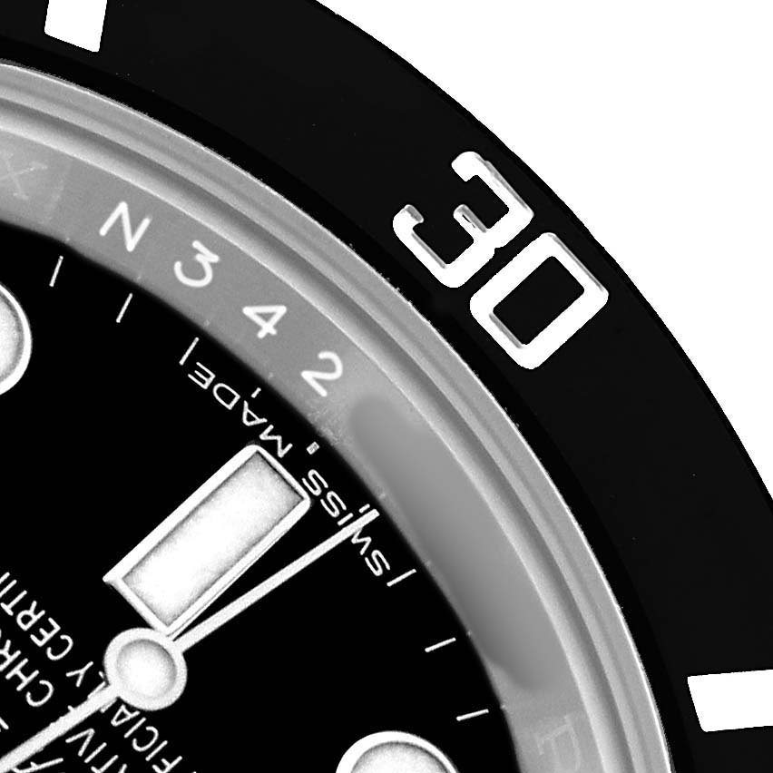The image shows a close-up of the bezel and part of the dial of a Rolex Submariner 114060 Men's Stainless Steel Black Dial, focusing on the 30-minute marker.