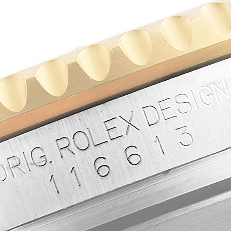 The image shows a close-up of the bezel and case side of a Rolex Submariner 116613 Men's Steel and Gold (two tone) Blue Dial 116613 Men's Steel and Gold (two tone) Blue Dial watch, including part of the model number.