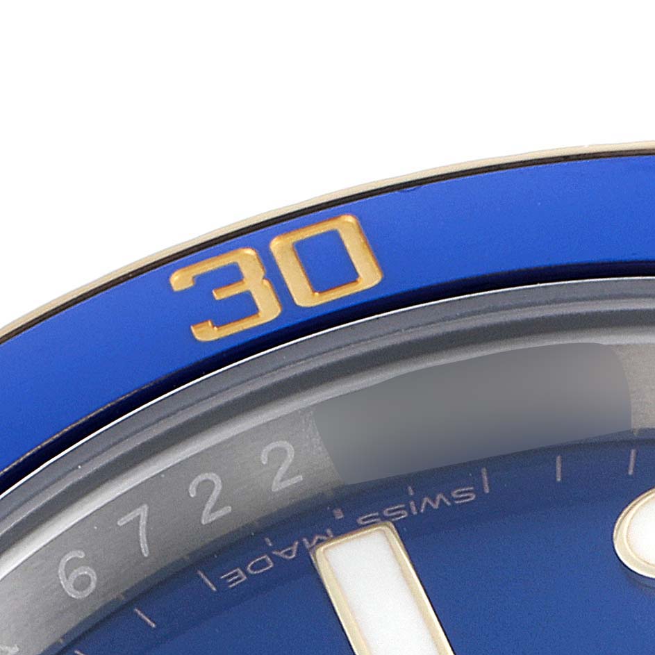 This image shows a close-up of the bezel and part of the dial of a blue Rolex Submariner 116613 Men's Steel and Gold (two tone) Blue Dial 116613 Men's Steel and Gold (two tone) Blue Dial watch, displaying the "30" minute marker.