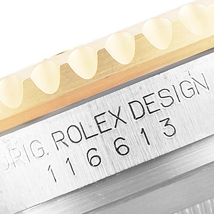 This image shows a close-up angle of the bezel and engraved model number (116613) on the Rolex Submariner 116613 Men's Steel and Gold (two tone) Blue Dial 116613 Men's Steel and Gold (two tone) Blue Dial watch.