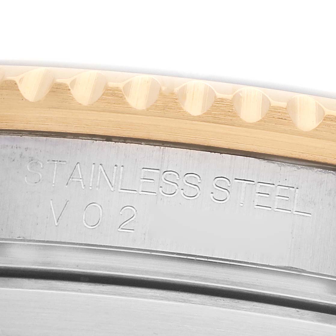 The image shows a close-up of the case side with engravings and the edge of the bezel of a Rolex Submariner 16613 Men's Steel and Gold (two tone) Black Dial.