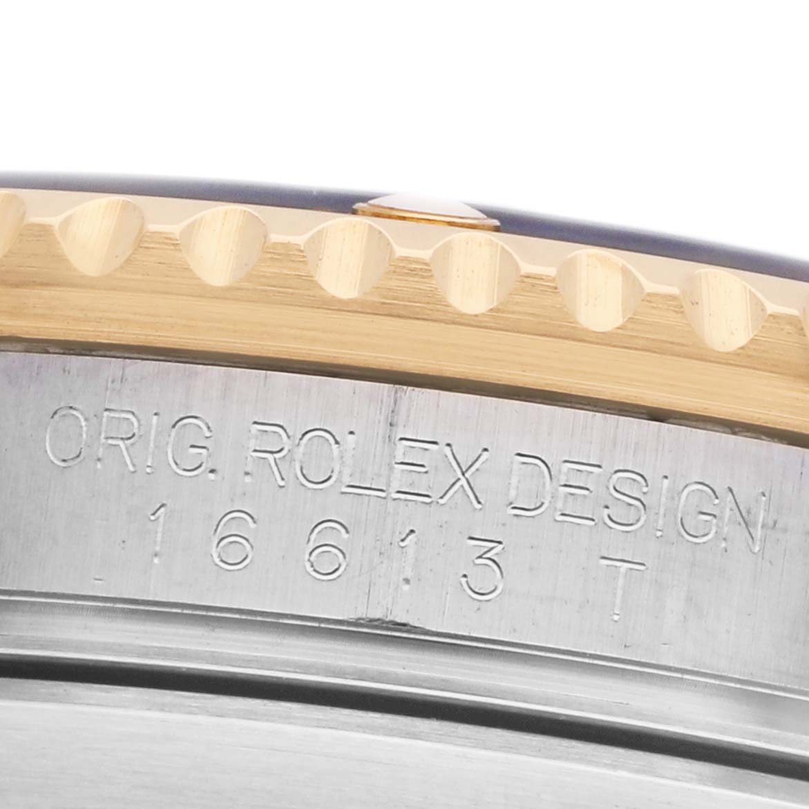 The image shows a close-up of the bezel and engraved case side of a Rolex Submariner 16613 Men's Steel and Gold (two tone) Black Dial, highlighting model details.