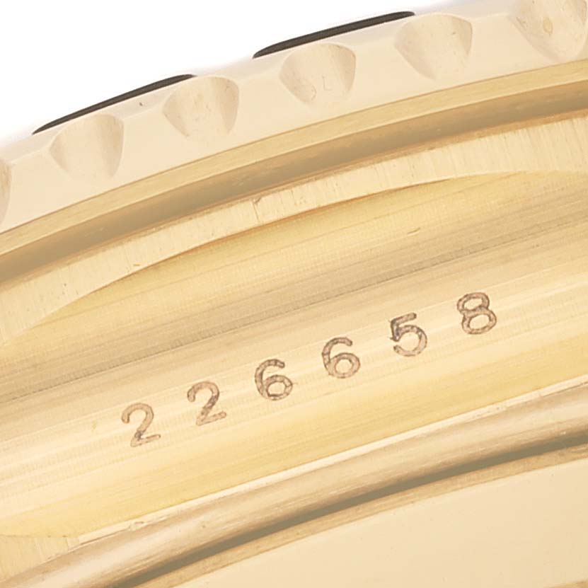 This image shows a close-up of the side view of a Rolex Yacht-Master 226658 Men's Yellow Gold Black Dial 226658 Men's Yellow Gold Black Dial watch bezel and part of its case with engraved numbers.