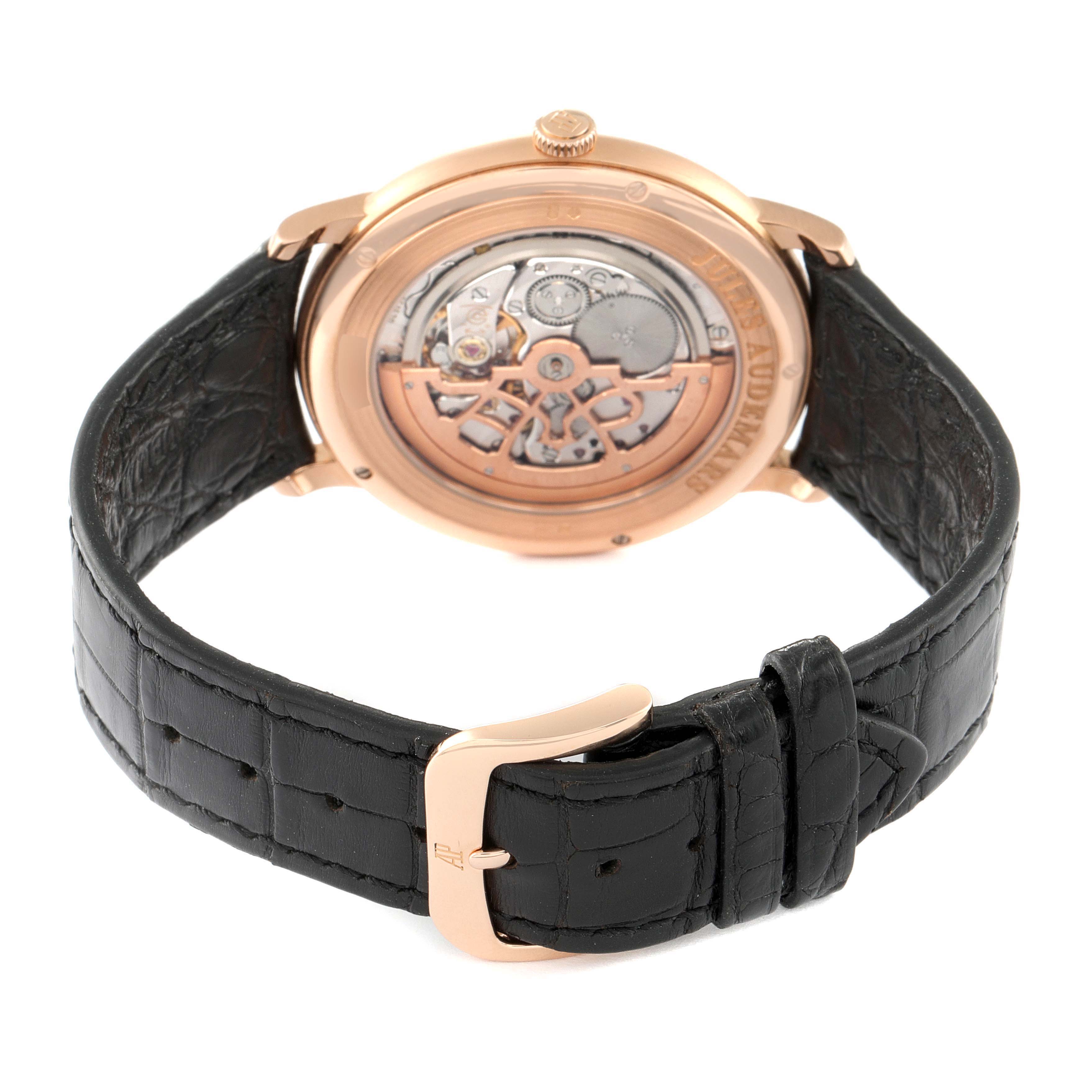 The image shows the back view of the Audemars Piguet Jules 15180OR.OO.A088CR.01 Men's Rose Gold Silver Dial 15180OR.OO.A088CR.01 Men's Rose Gold Silver Dial watch, highlighting its movement and black leather strap.