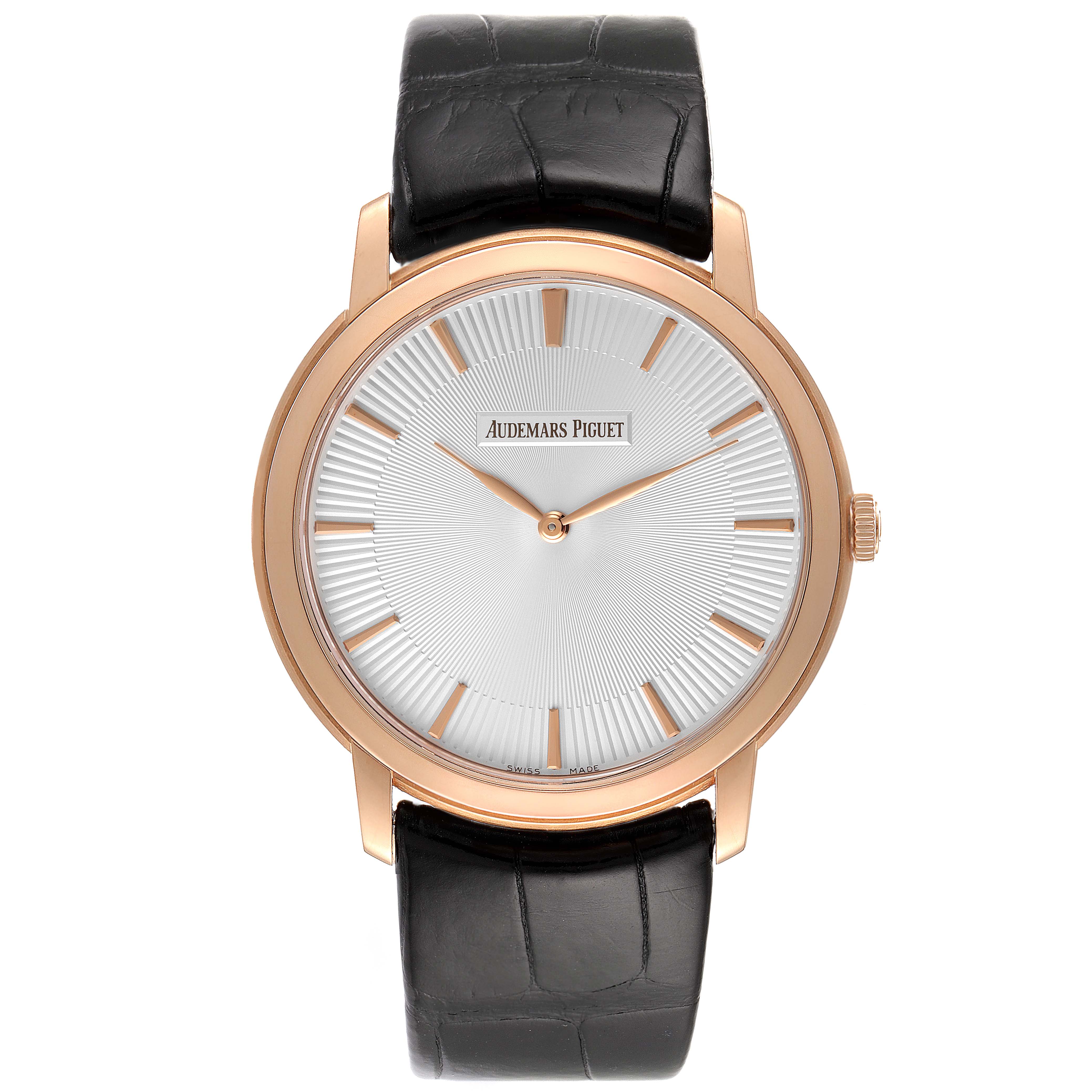 The image shows a front view of a Jules model by Audemars Piguet with a gold case, white dial, and black leather strap.