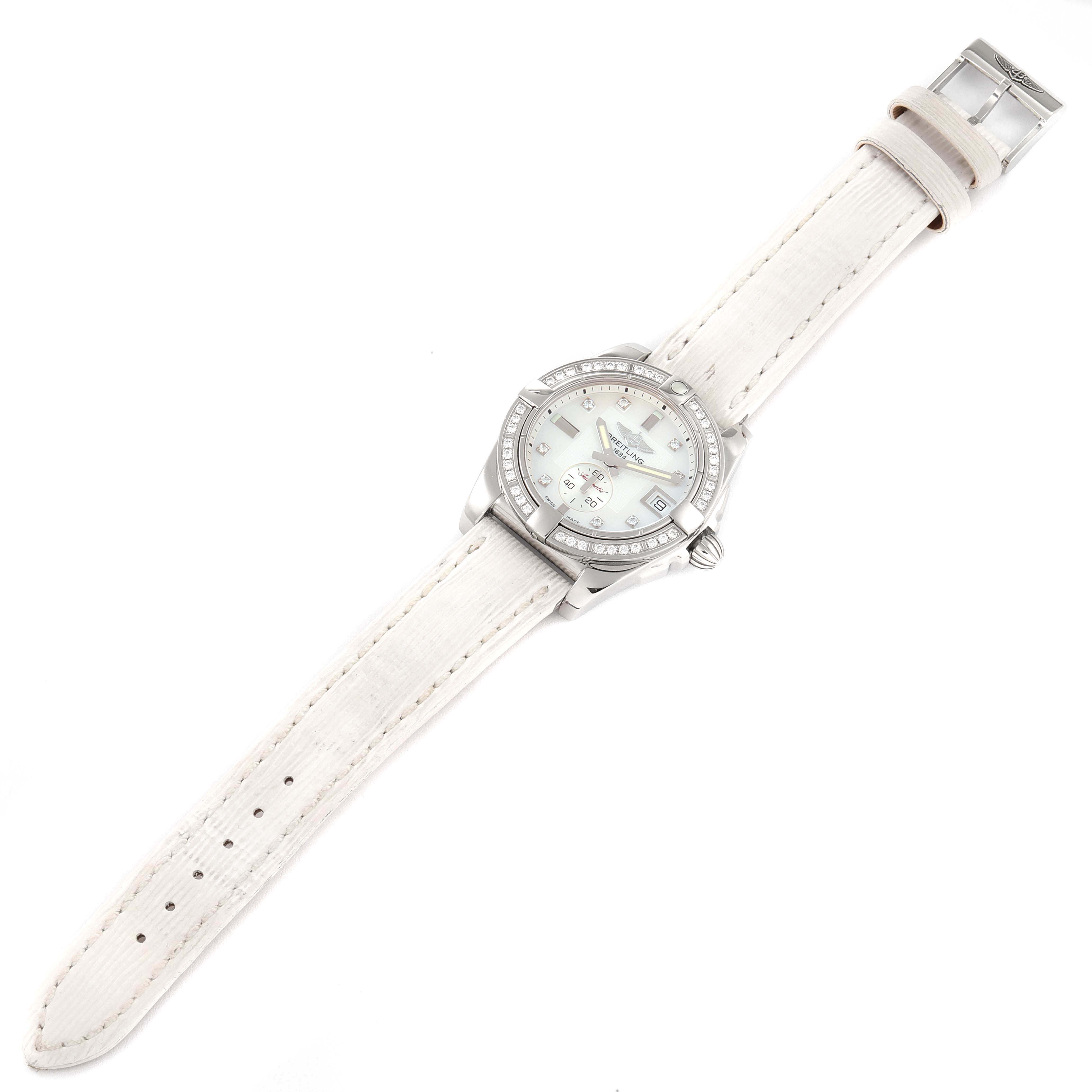 The image shows a top view of the Breitling A37330 Women's Stainless Steel Mother of Pearl Dial A37330 Women's Stainless Steel Mother of Pearl Dial Galactic 36 MOP Dial Diamond Steel Ladies Watch A37330, featuring its dial, bezel, and white strap.