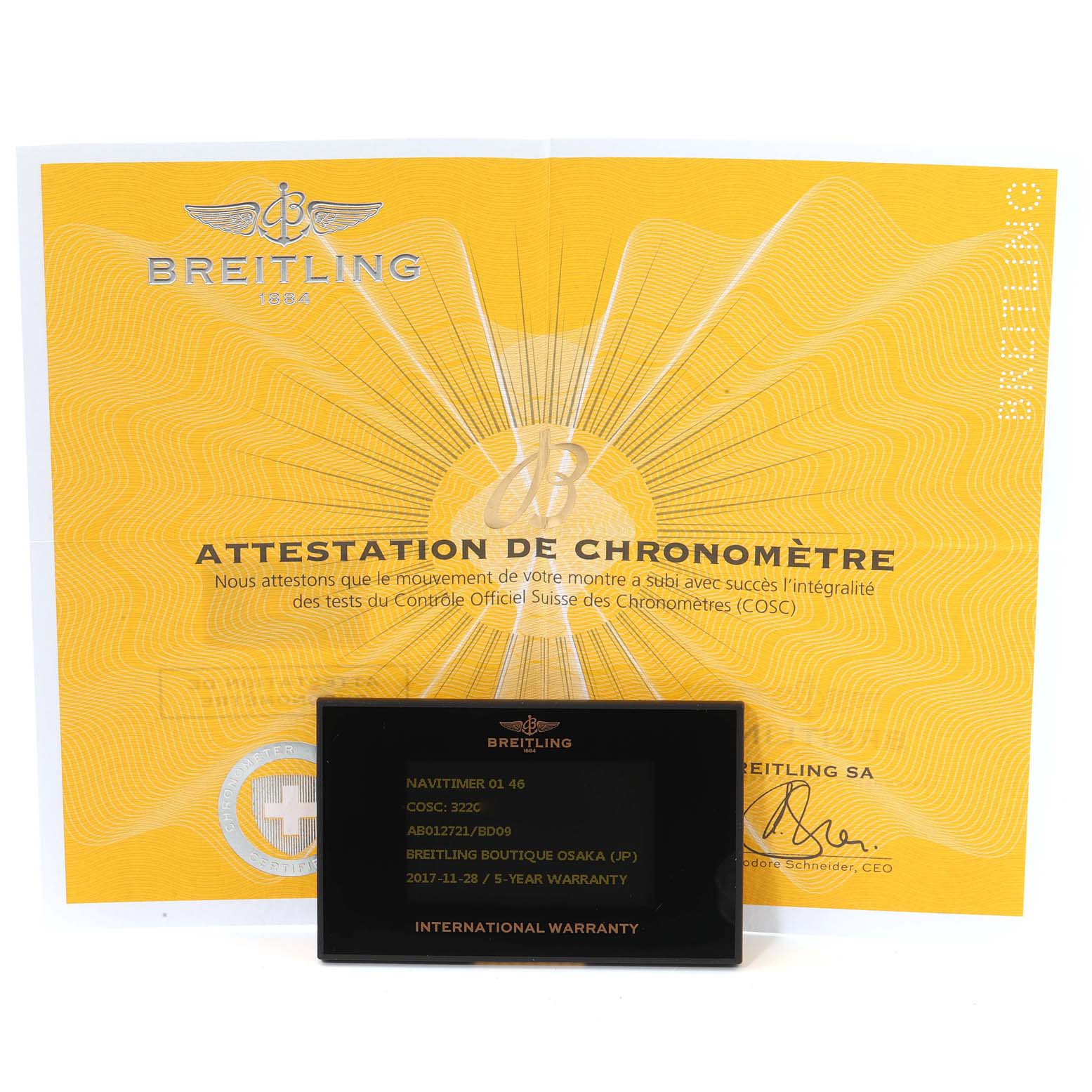 The image shows a Breitling Navitimer AB0127211C1A1 Men
s Stainless Steel Black Dial AB0127211C1A1 Men
s Stainless Steel Black Dial warranty card and chronometer certification paper, photographed from a front angle.