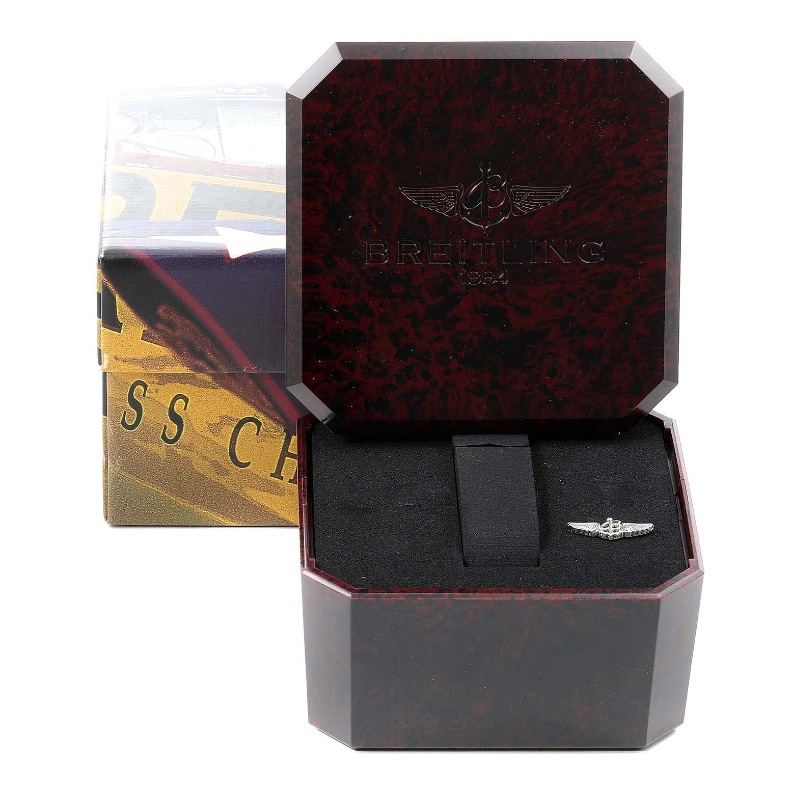 The image shows a open Breitling Navitimer AB0120 Men's Stainless Steel Black Dial AB0120 Men's Stainless Steel Black Dial watch box with an emblem inside, viewed from the front.