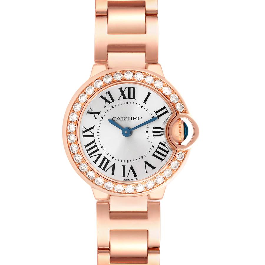 The Cartier Ballon Bleu watch is shown from the front, highlighting its round face, Roman numerals, and diamond-studded bezel.