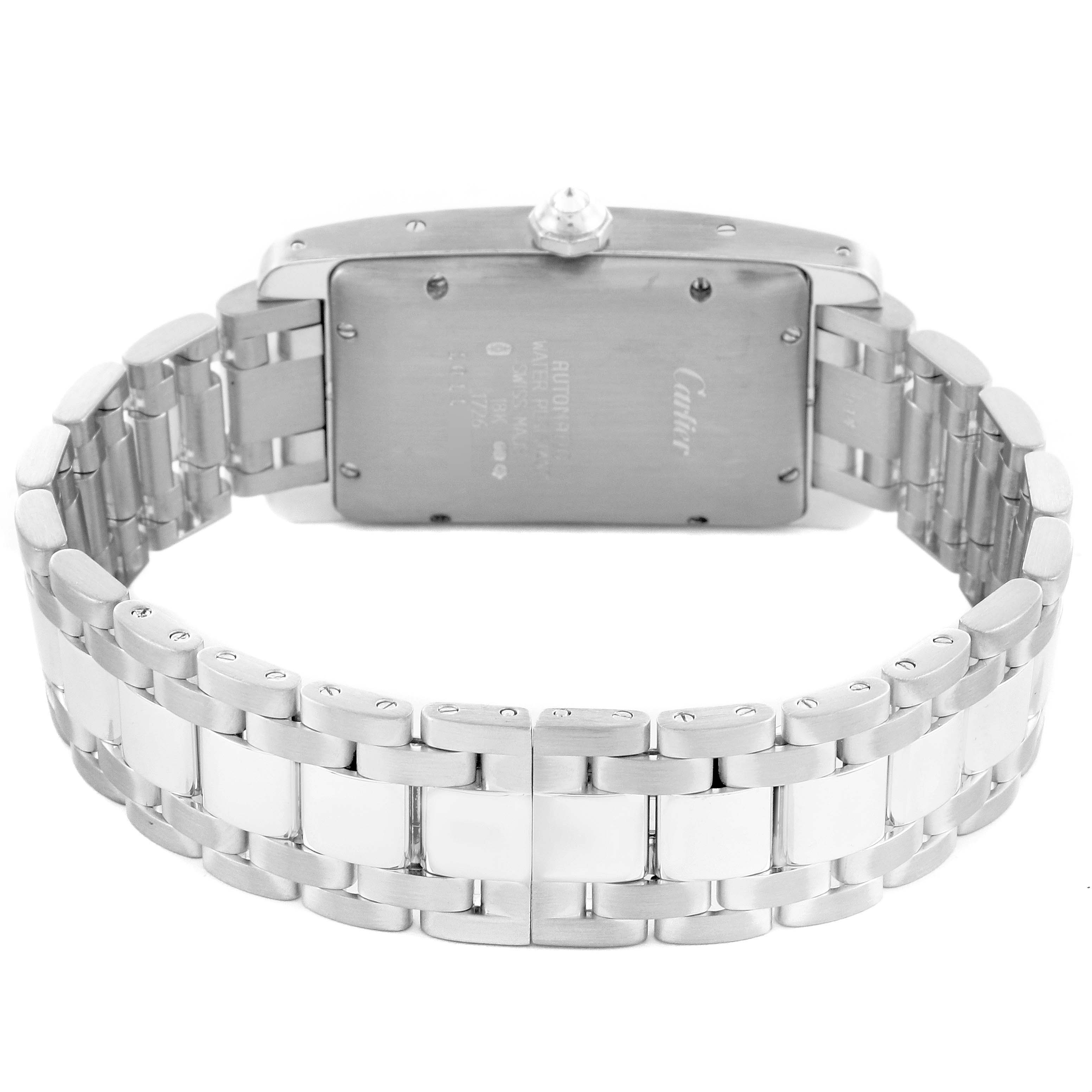 The Cartier Tank Américaine watch is shown from the back, featuring the metal bracelet and case back.