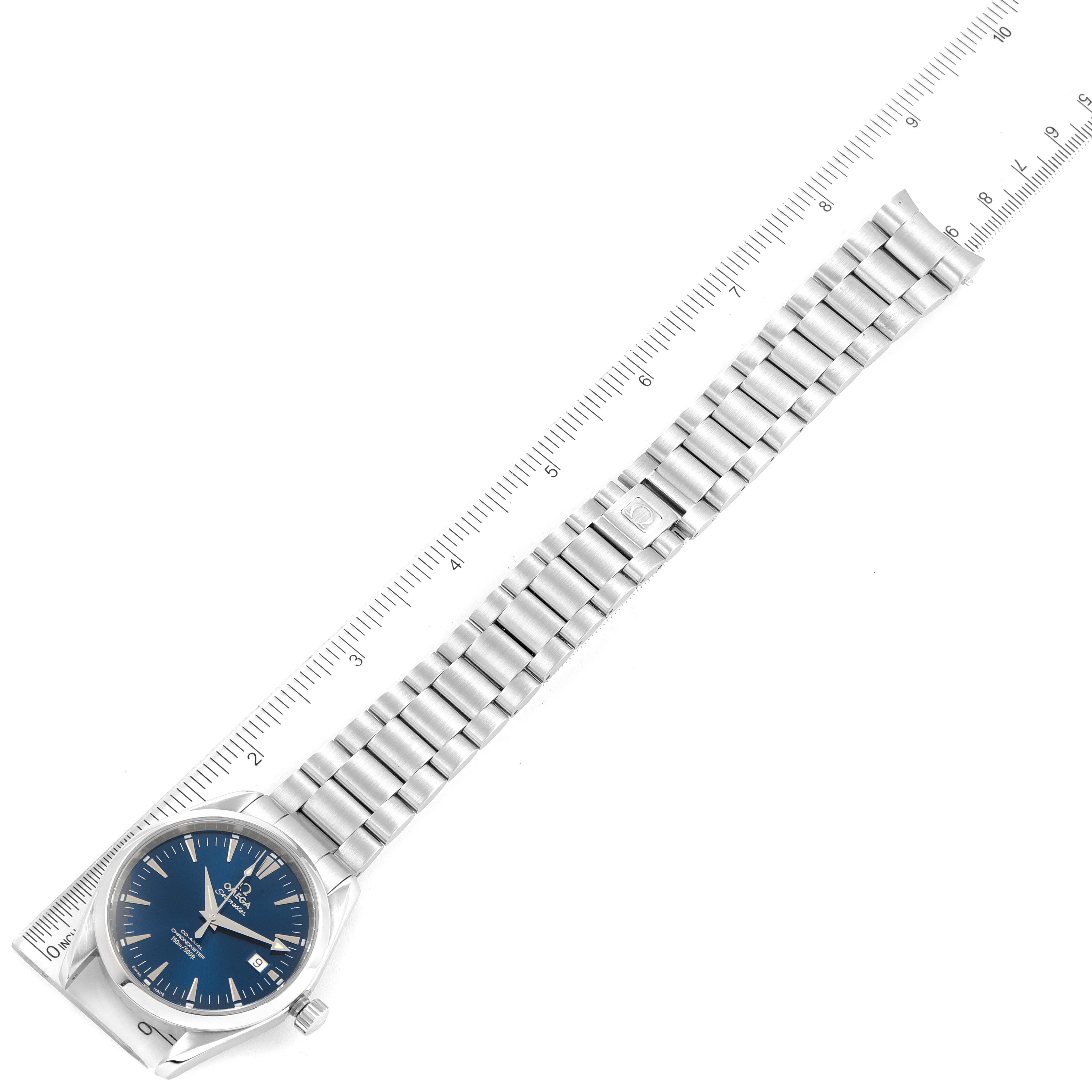 The image shows an Omega Aqua Terra 2503.80.00 Men's Stainless Steel Blue Dial 2503.80.00 Men's Stainless Steel Blue Dial watch laid parallel to a ruler, showcasing its dial, case, and bracelet.