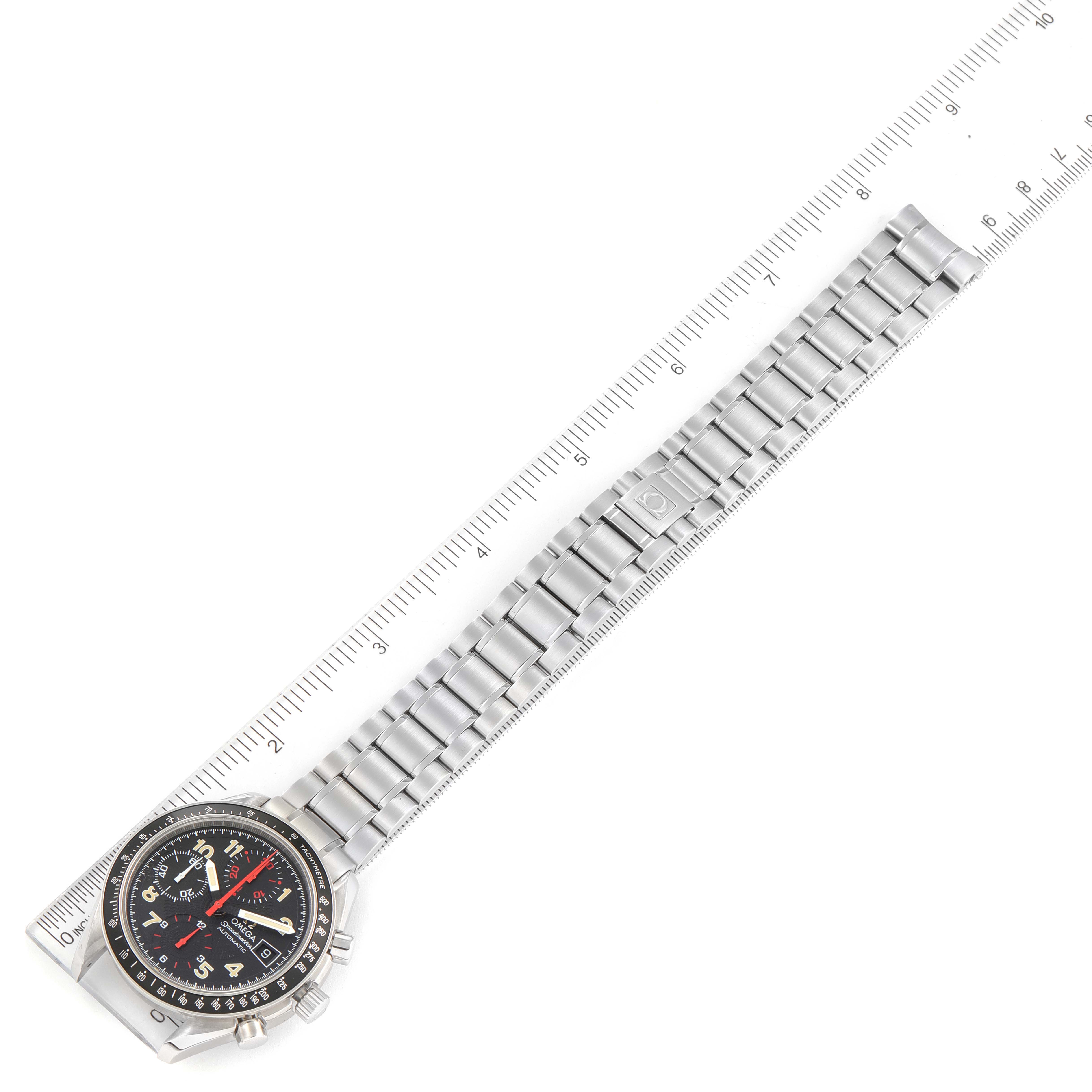 The Omega Speedmaster 3513.53.00 Men
s Stainless Steel Black Dial 3513.53.00 Men
s Stainless Steel Black Dial watch is shown from a top-down angle, highlighting its face and stainless steel bracelet alongside a ruler.