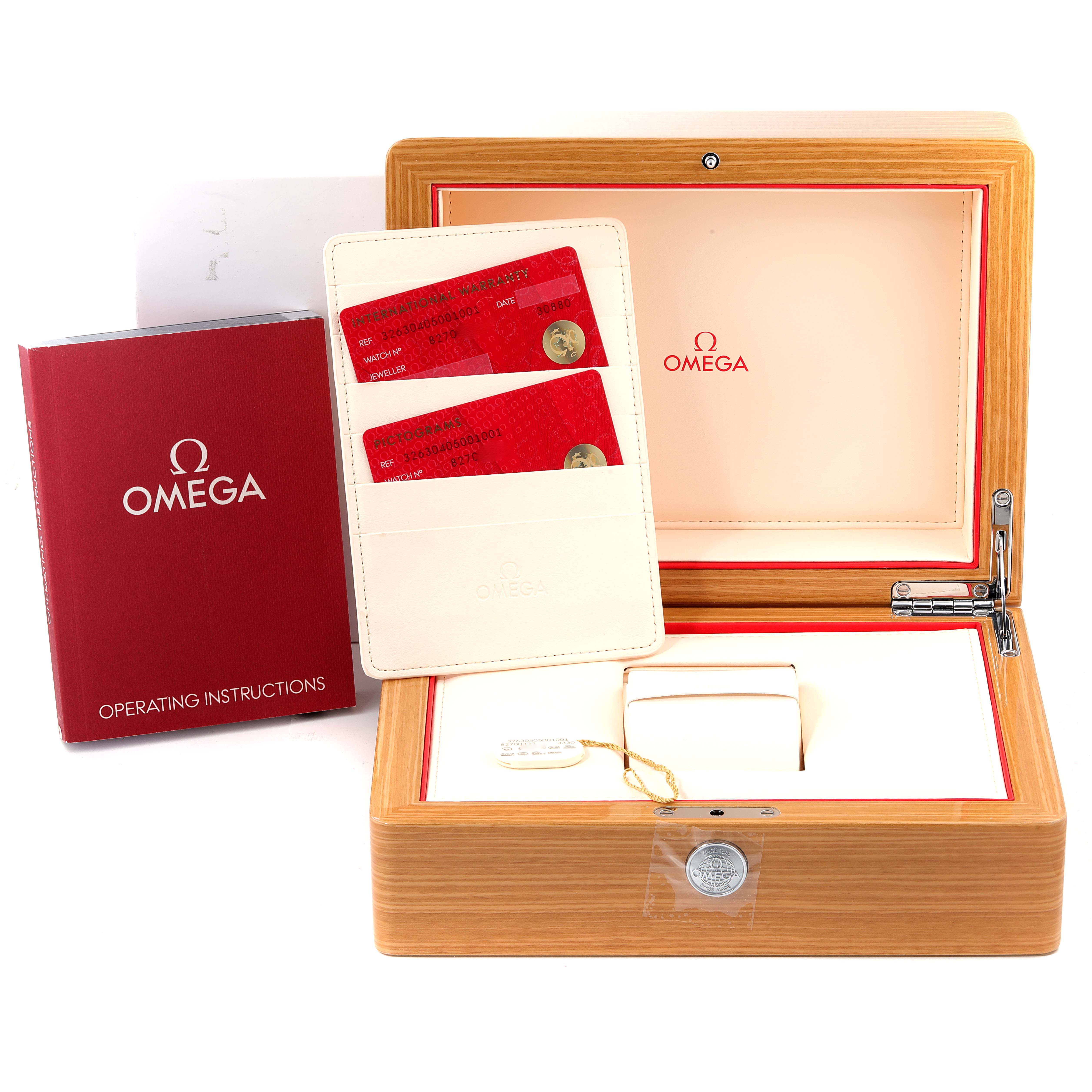 The image shows the packaging, warranty cards, and operating instructions for an Omega Speedmaster 326.30.40.50.01.001 Men
s Stainless Steel Black Dial 326.30.40.50.01.001 Men
s Stainless Steel Black Dial watch.