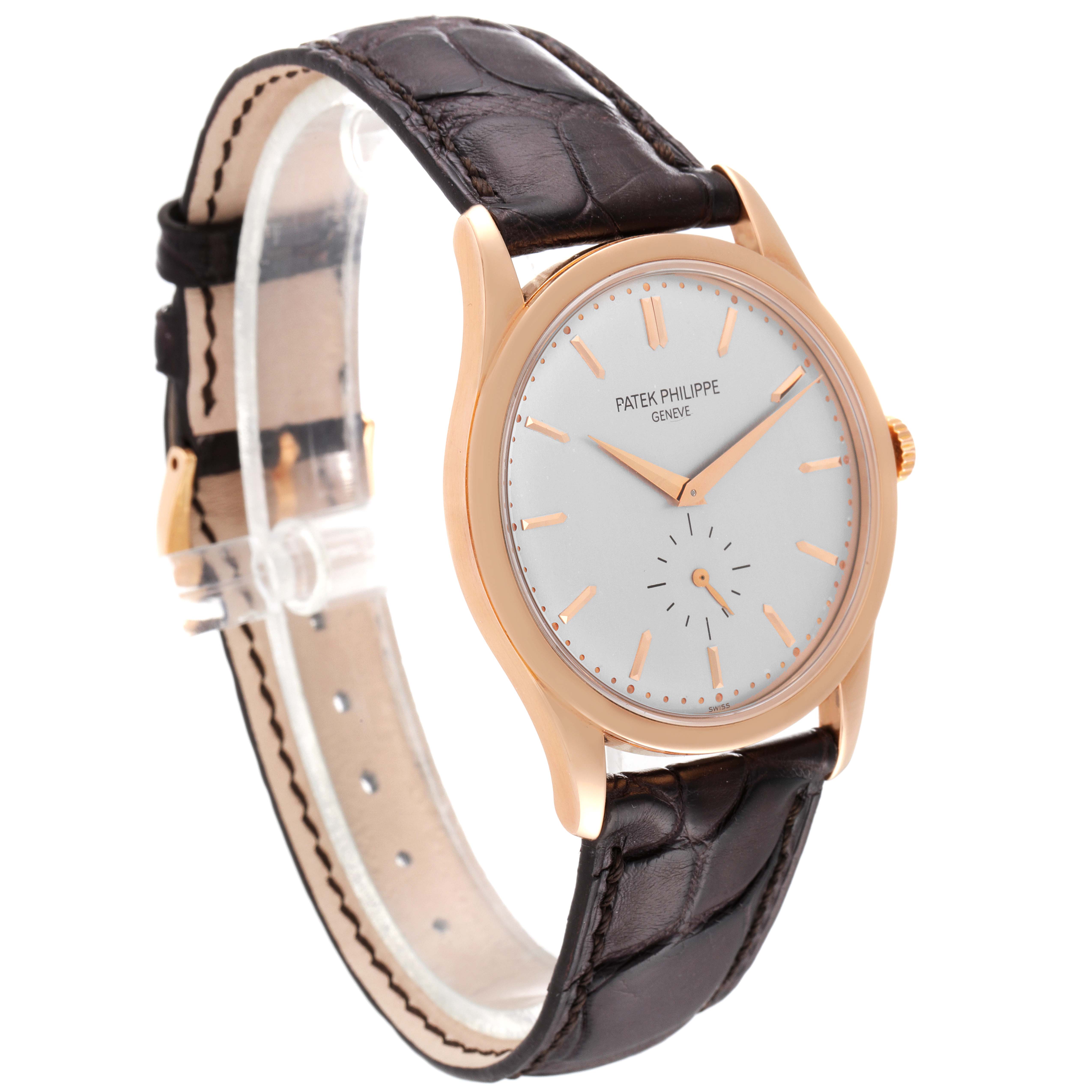 The Calatrava by Patek Philippe is shown at a three-quarter angle, highlighting the dial, case, and leather strap.