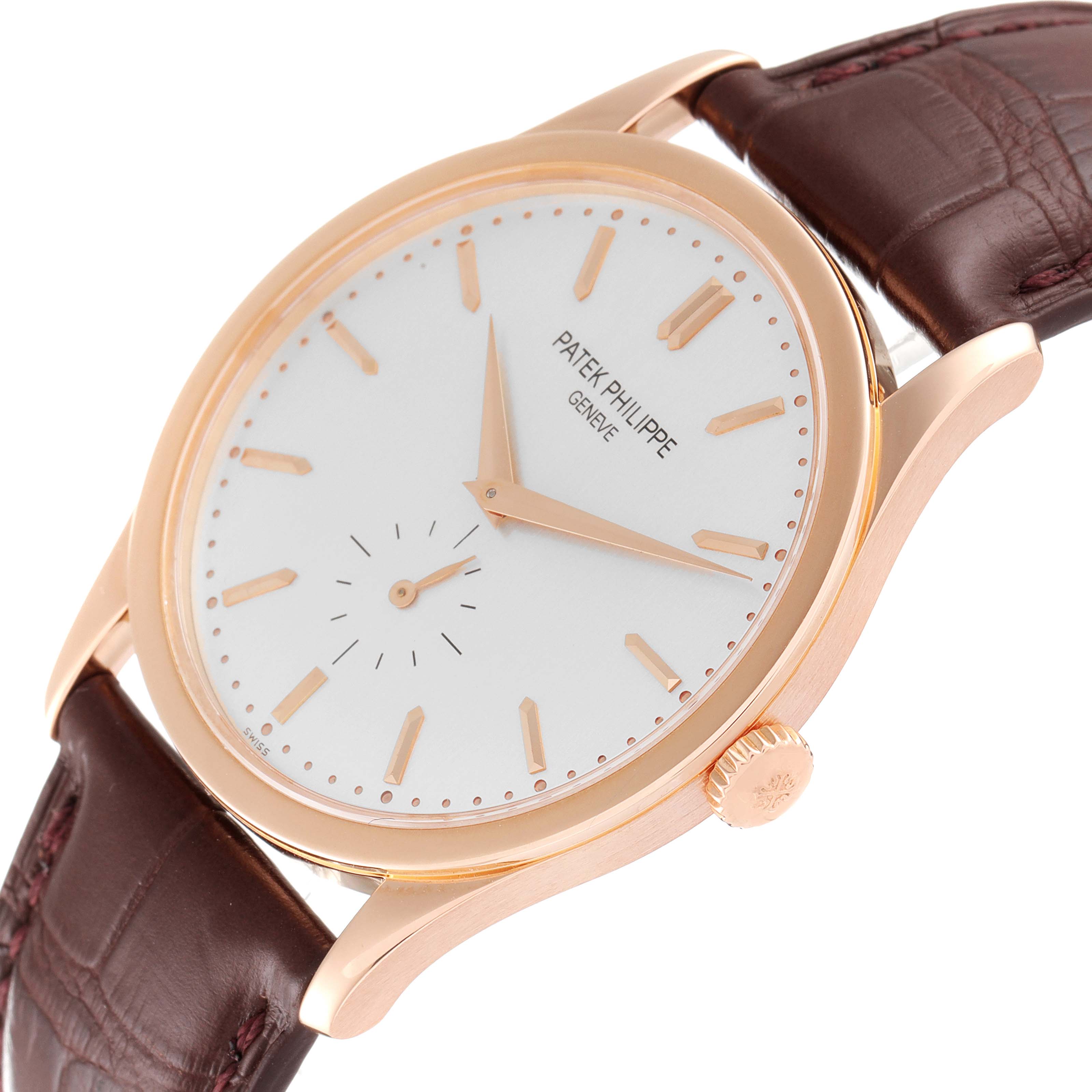 The image shows a front-side angle of a Patek Philippe Calatrava 5196R Men's Rose Gold Silver Dial 5196R Men's Rose Gold Silver Dial watch, highlighting its face, crown, and brown leather strap.