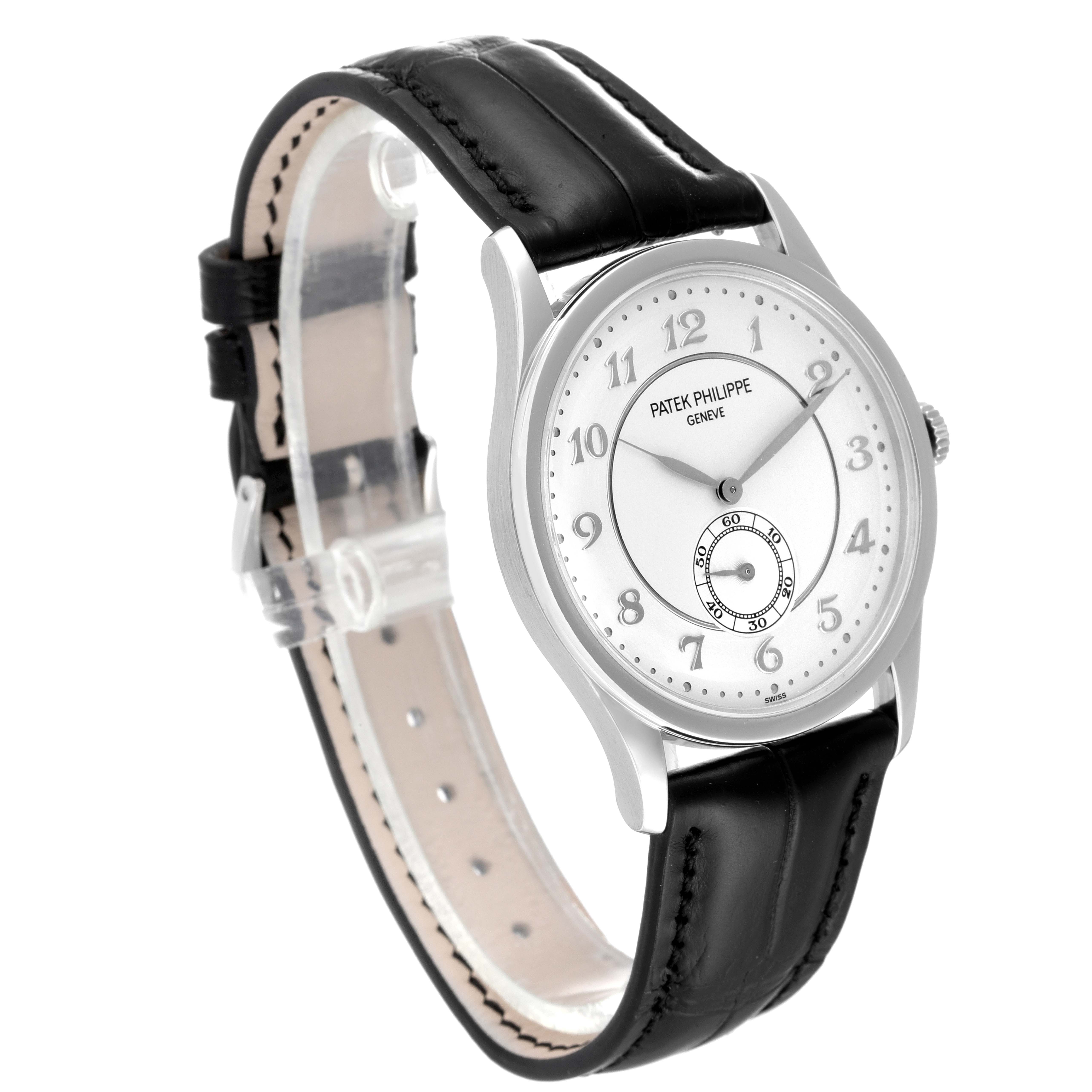 The image shows a Patek Philippe Calatrava 5196P-001 Men's Platinum Silver Dial 5196P-001 Men's Platinum Silver Dial watch from the side, highlighting its face, band, and crown.