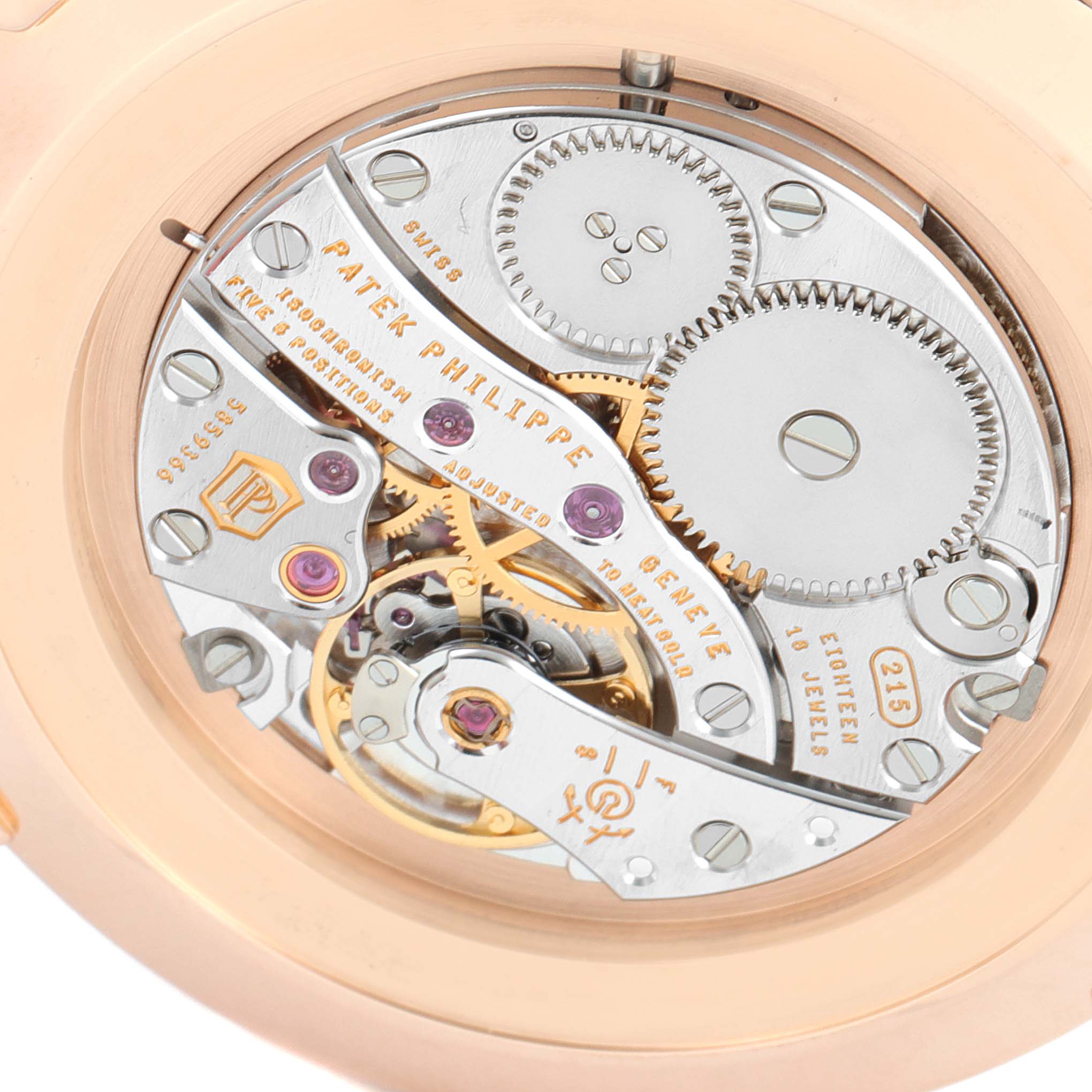 The image shows the intricate movement and mechanics of a Patek Philippe Calatrava 5119R Men's Rose Gold White Dial 5119R Men's Rose Gold White Dial model watch, viewed from the back.